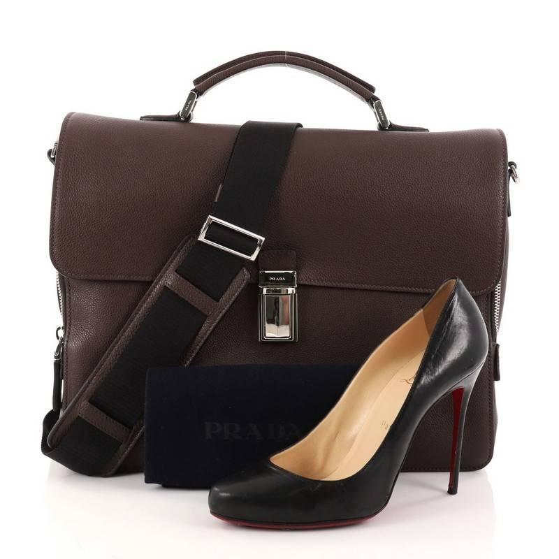 This authentic Prada Convertible Flap Briefcase Vitello Daino Medium is a chic and functional work accessory made for stylish professionals. Crafted in luxurious brown vitello daino leather, this briefcase features a leather top handle, exterior zip