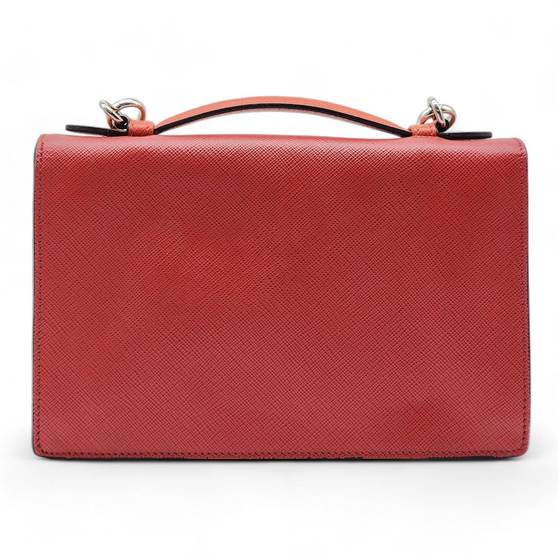 Prada Convertible Sound Bag Vernice Saffiano Leather in Red.

Additional information:
Material: Leather 
Color: Red
Country: Italy
Condition: Preloved condition with signs of wear, Exterior and interior have minor marks.
Includes shoulder strap and