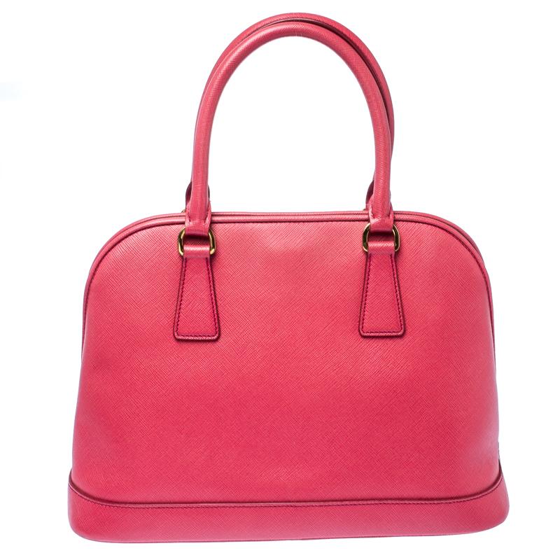 This stunning Promenade satchel is high on appeal and style. Dazzling in a classy pink shade, the bag is crafted from Saffiano leather and features two rolled handles. The snap button closure leads way to a nylon interior with enough space for your