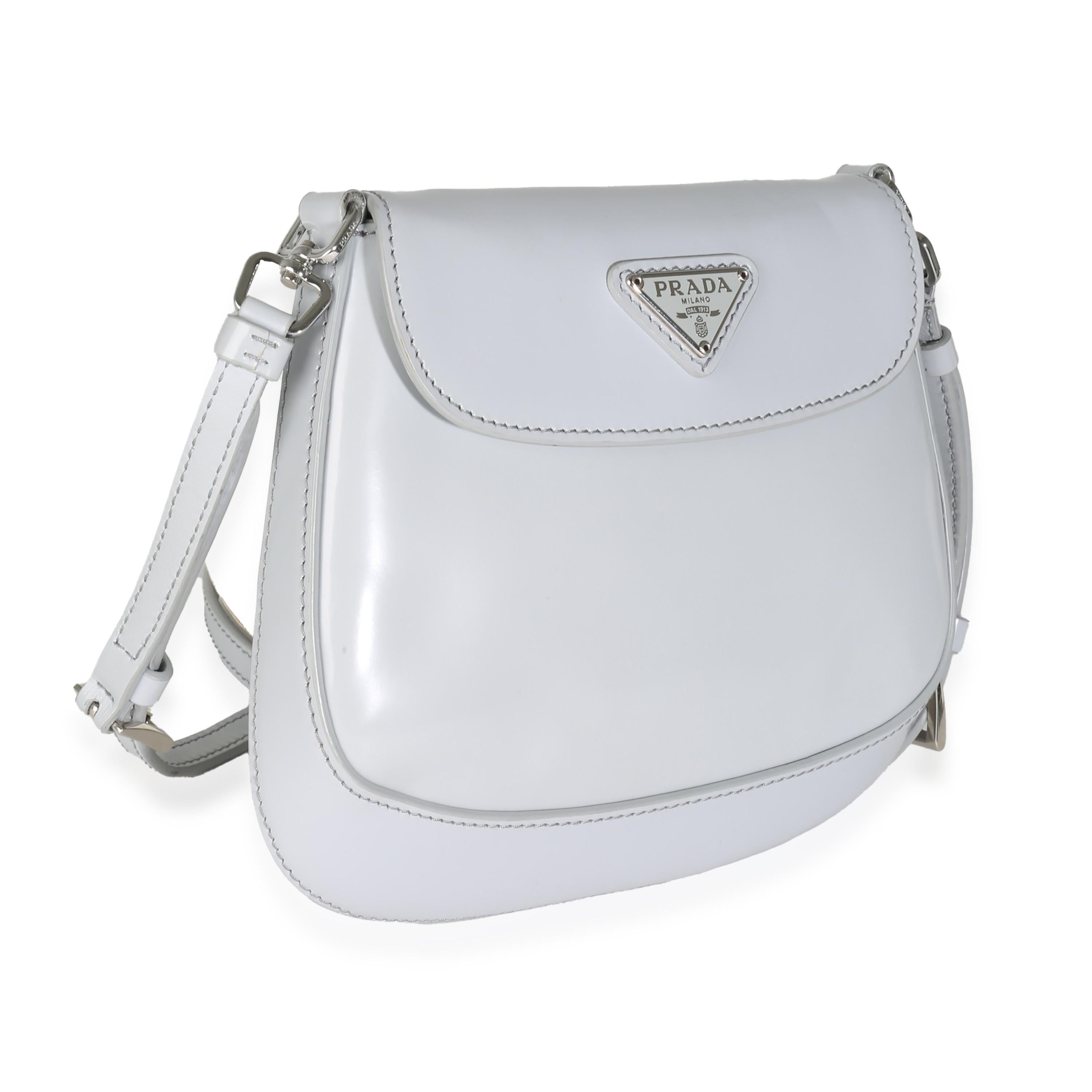 Listing Title: Prada Cornflower Brushed Leather Mini Cleo
SKU: 142286
MSRP: 2800.00 USD
Condition: Pre-owned 
Condition Description: Reimagining a classic design from the ‘90s, the Cleo bag from Prada epitomizes pared-back luxury. Soft curved lines