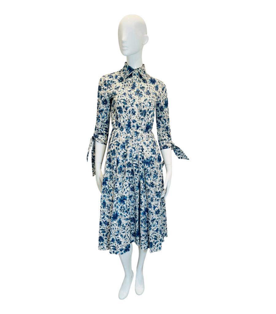 Prada Cotton Floral Print Shirt Dress

Ivory midi dress designed with all-over floral prints in blue.

Designed with collared neckline, button centre closure and pleated skirt.

Featuring three-quarter sleeves with tie-up cuffs.

Size –