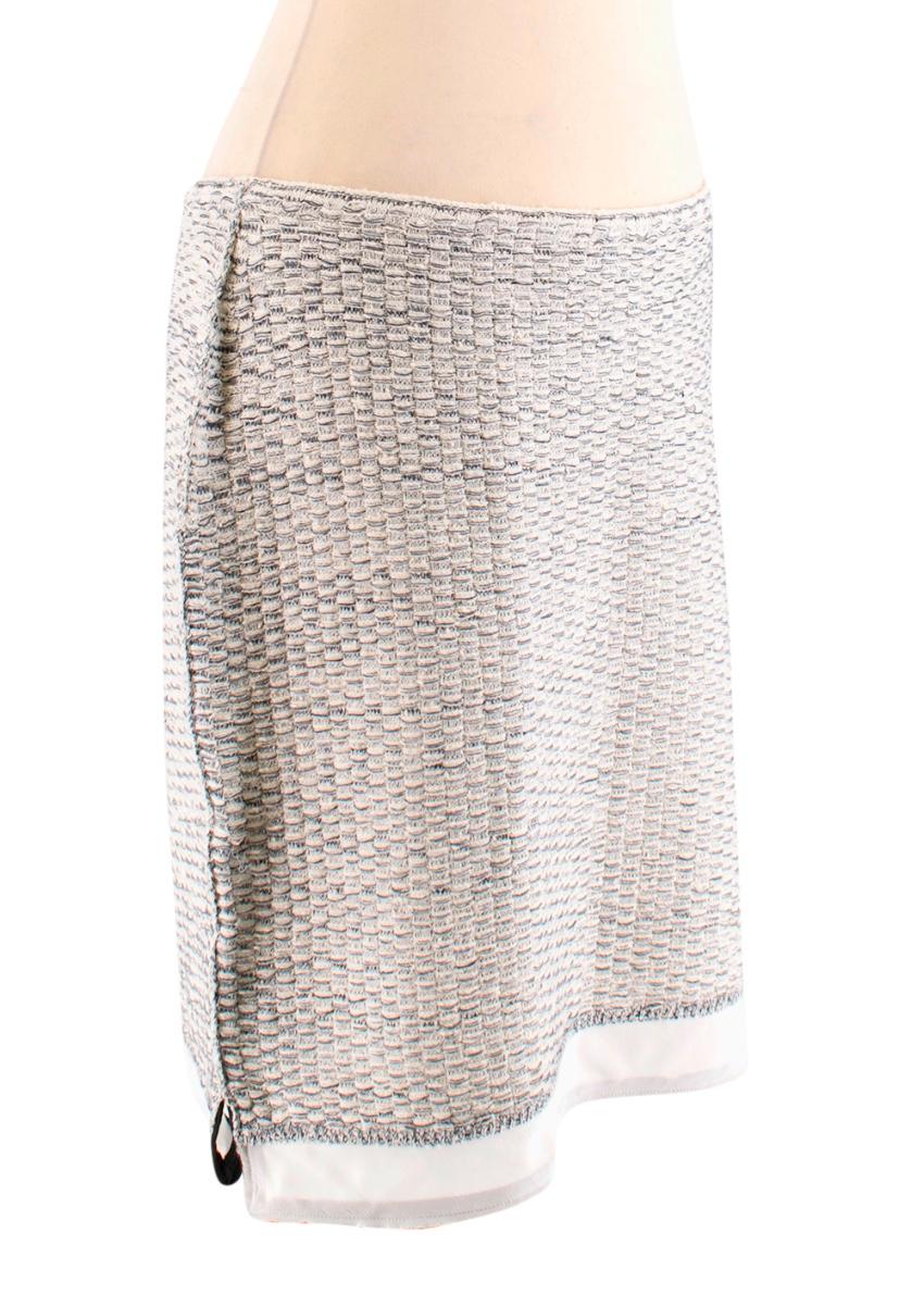 Prada Cream/Black Stretch Tweed Skirt

-Cream/black knit body
- silk hem with black trim 
- lightweight and stretch 

Approx in CM
Measurements are taken laying flat, seam to seam. 

Waist - 35 cm
Width - 50 cm
Length - 46 cm