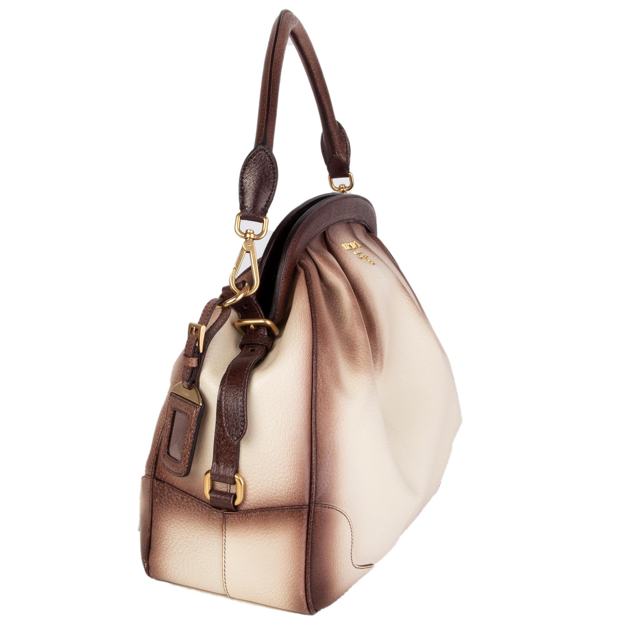 Prada pleated doctors bag in cream Cinghiale (pigskin) leather with burnished brown edges and pleats. Frame closure. Lined in dark brown logo nylon with an open pocket against the front and a zipper pocket against the back. Has been carried and is