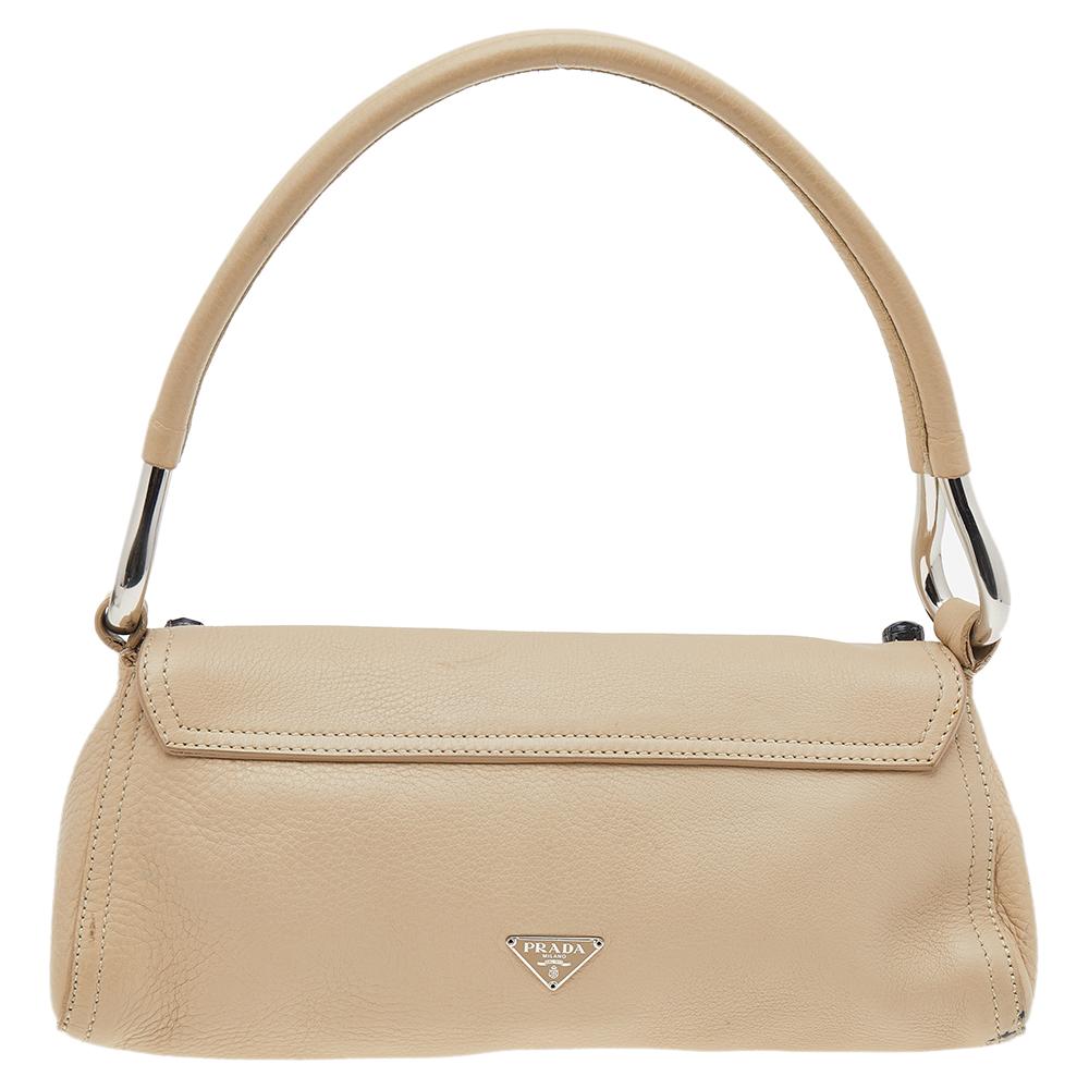 This cream flap bag from the house of Prada is lovely. It is crafted from leather and designed with a shoulder handle and beads on the flap. This piece will do justice to your style in an easy way.

Includes: Original Dustbag, Authenticity Card,