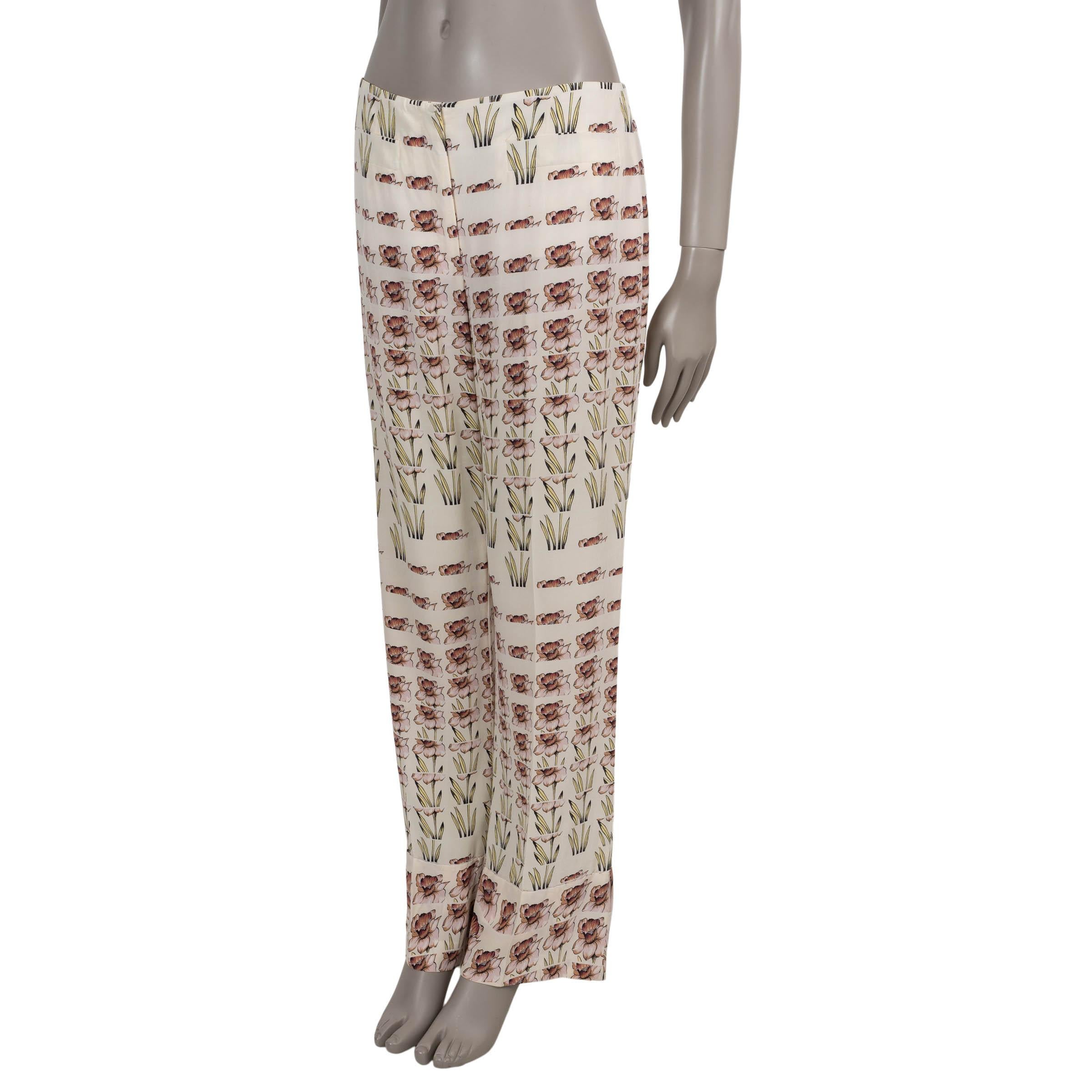 These 100% authentic Prada pants in Alabastro (cream) crêpe de chine silk (100%) feature a delicate Daffodil print in pink and yellow, adding a romantic touch to a refined silhouette. Designed with a high waist and straight legs, they include two