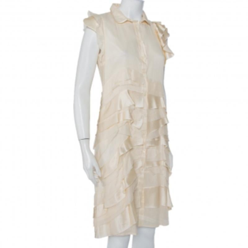 This flattering and luxurious dress by Prada is stunning. It has been crafted from pure silk and comes in a lovely cream hue. The shirt dress has a detachable collar detail, ruffle detailing that adds interest and a button front closure.
