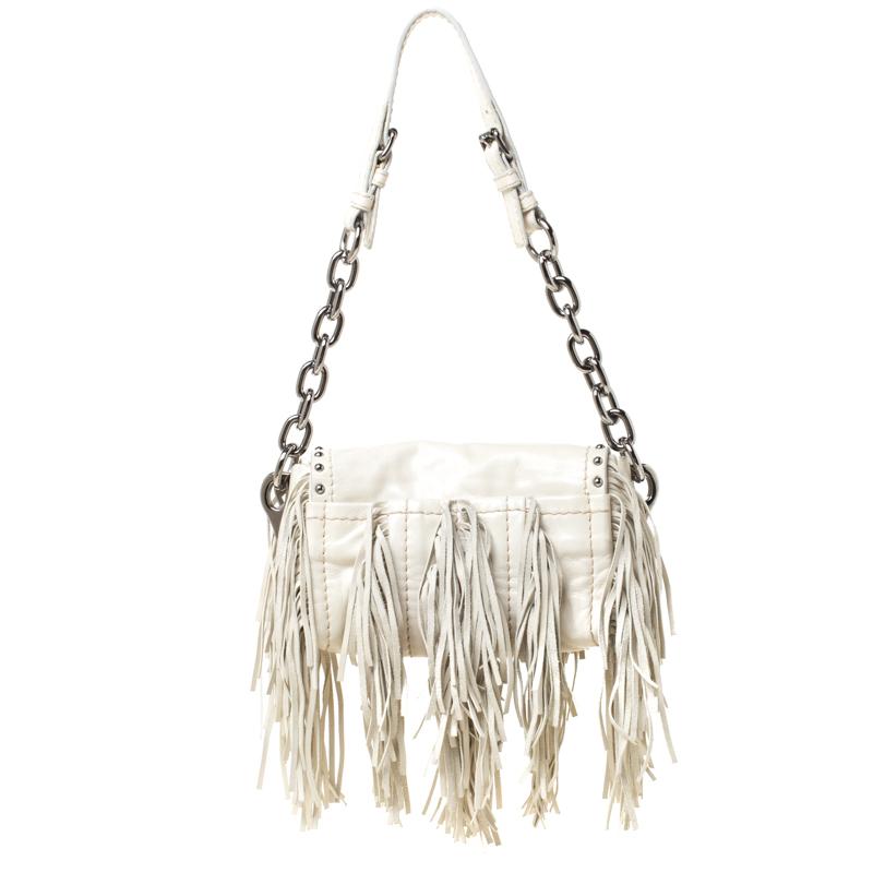 You will love carrying this stunning bag from Prada that is sure to grab you a lot of compliments. The cream bag is crafted from leather and features a chic silhouette. It flaunts fringe detailing on the exterior and comes with a push lock front
