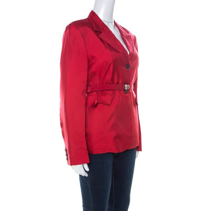 Picked from Prada's collection of clothes is this gorgeous jacket that delights our sight with its colour and details. The jacket arrives in crimson red with long sleeves, front buttons and a push-buckle belt for adding shape.

