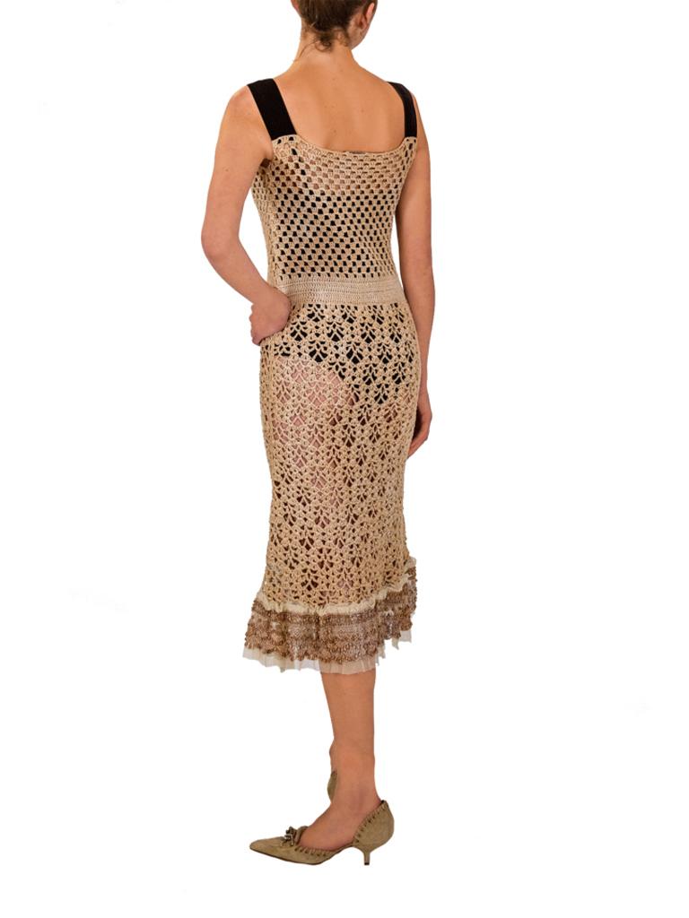 Rare Prada natural straw coloured crochet dress, with black silk velvet ribbon straps and wooden beading detail to pockets, neckline and hem. From the SS 2006 collection. 



Vintage designer day dresses sourced by Stelios Hawa with the objective to