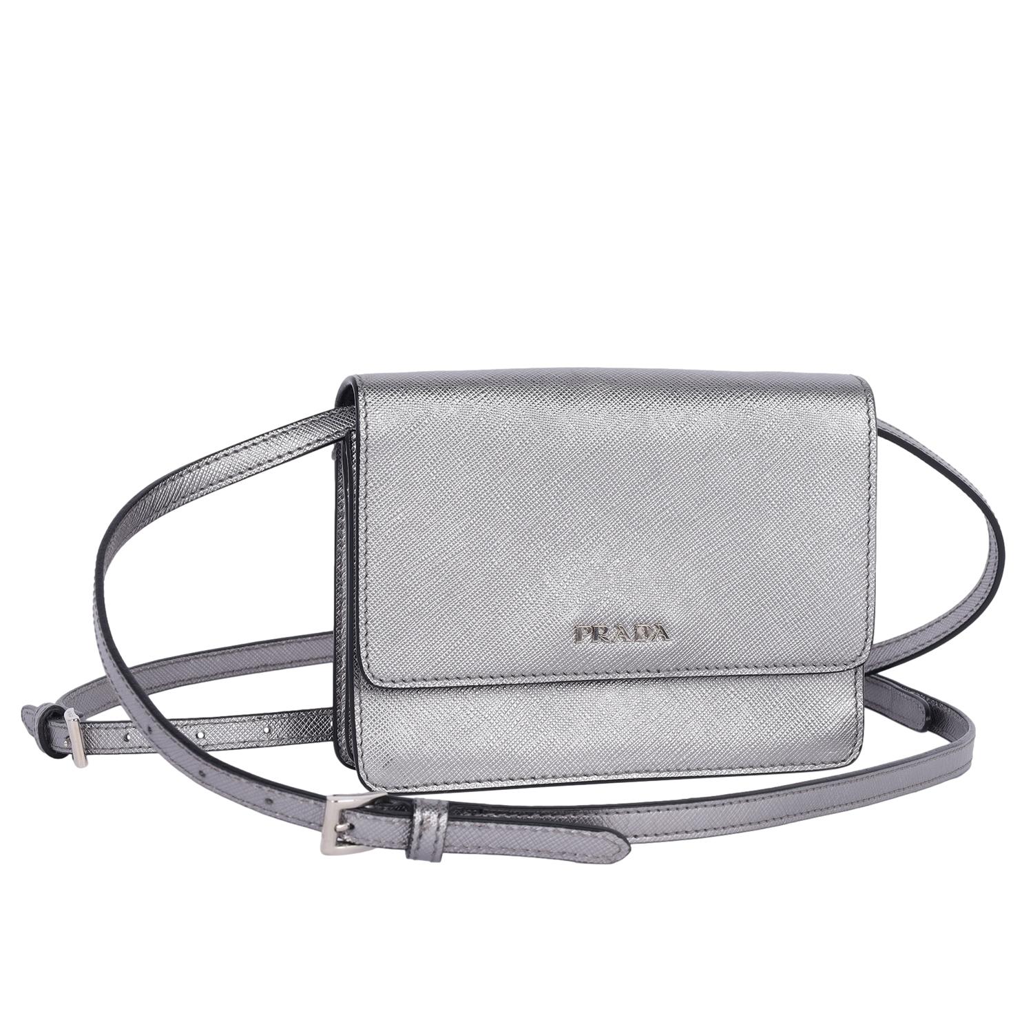 Authentic, pre-owned Prada Cromo Saffiano Lux Leather cross body bag. Features silver leather body, front flap closure with snap, logo Prada front, 2 larger divided pockets, 2 slip pockets, zipper middle pocket, 3 cc slots, silver hardware,