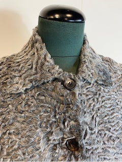 Prada crop top bomber jacket in gray astrakhan fur.