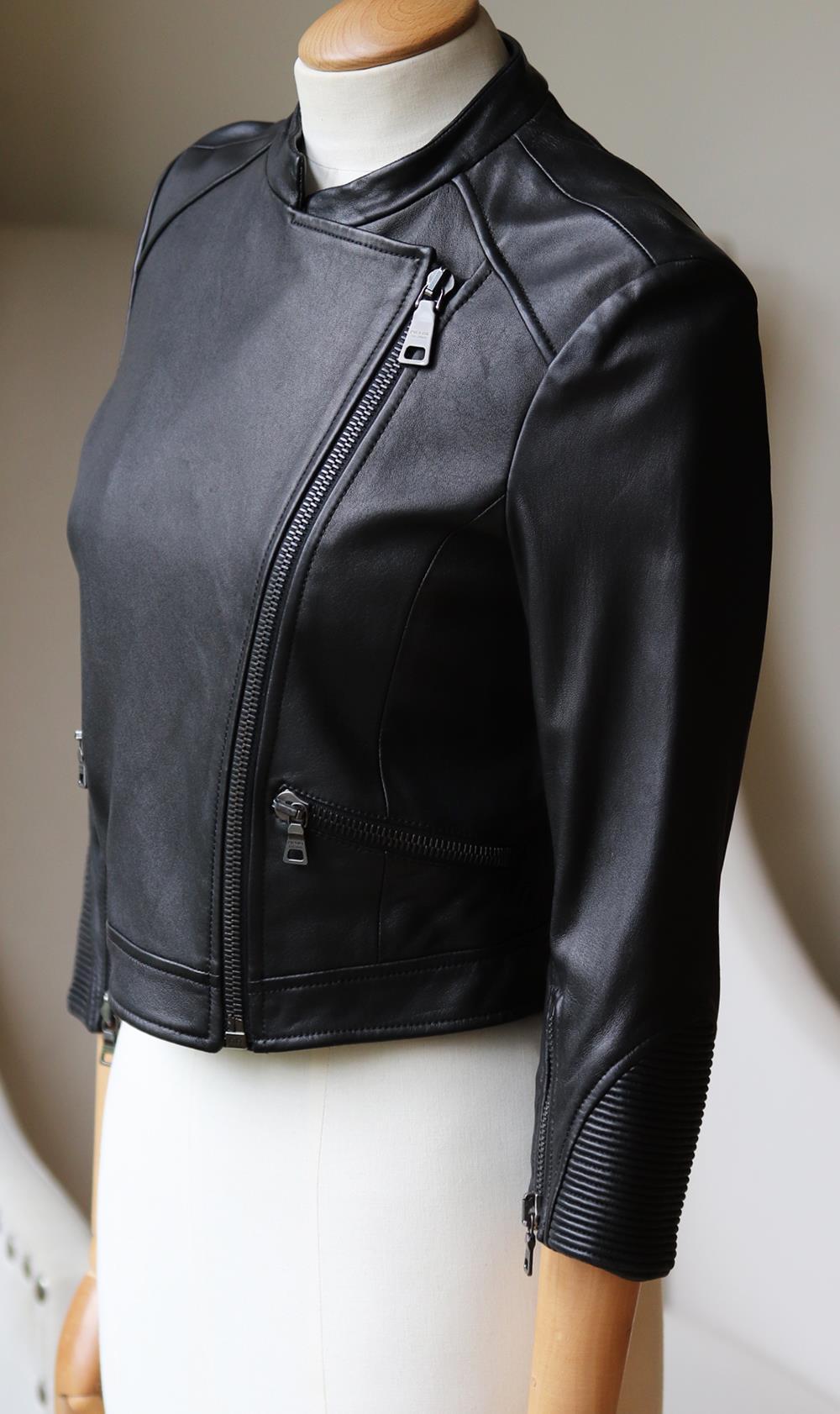 This Prada cropped biker jacket is made from buttery-soft stretch leather and punctuated with ribbed details along the cropped sleeves.
Black leather.
Asymmetric zip fastening through front.
100% Leather (Lamb); lining: 100% viscose.

Size: IT 38