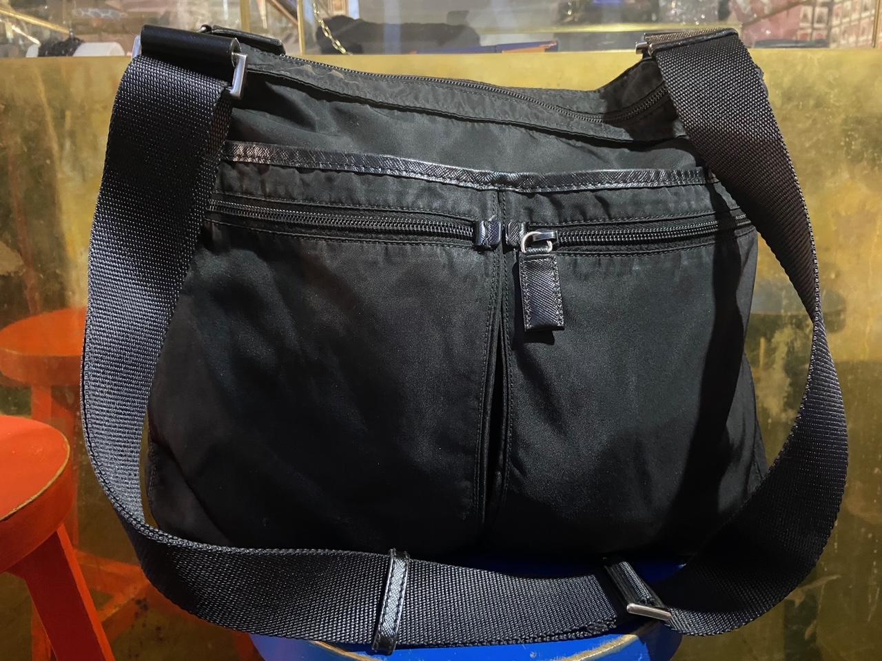 Vintage Mini Prada Tote Bag Features Acrylic outer layer. Black leather handle, Zip on the top and inside pocket. Prada Logo in metal on front of bag. In excellent vintage condition. 

Brand: Prada
Color: Black
Fabric: Canvas/Leather
Year / Season :