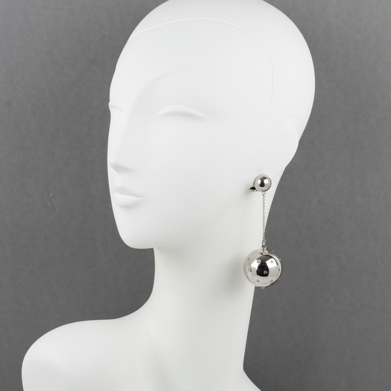 Stunning oversized dangling clip-on earrings designed by Prada, Italy. These simple yet elegant earrings will make you shine no matter what the occasion is. They come from the house of Prada. This pair is designed in a clip-on style with a heavy