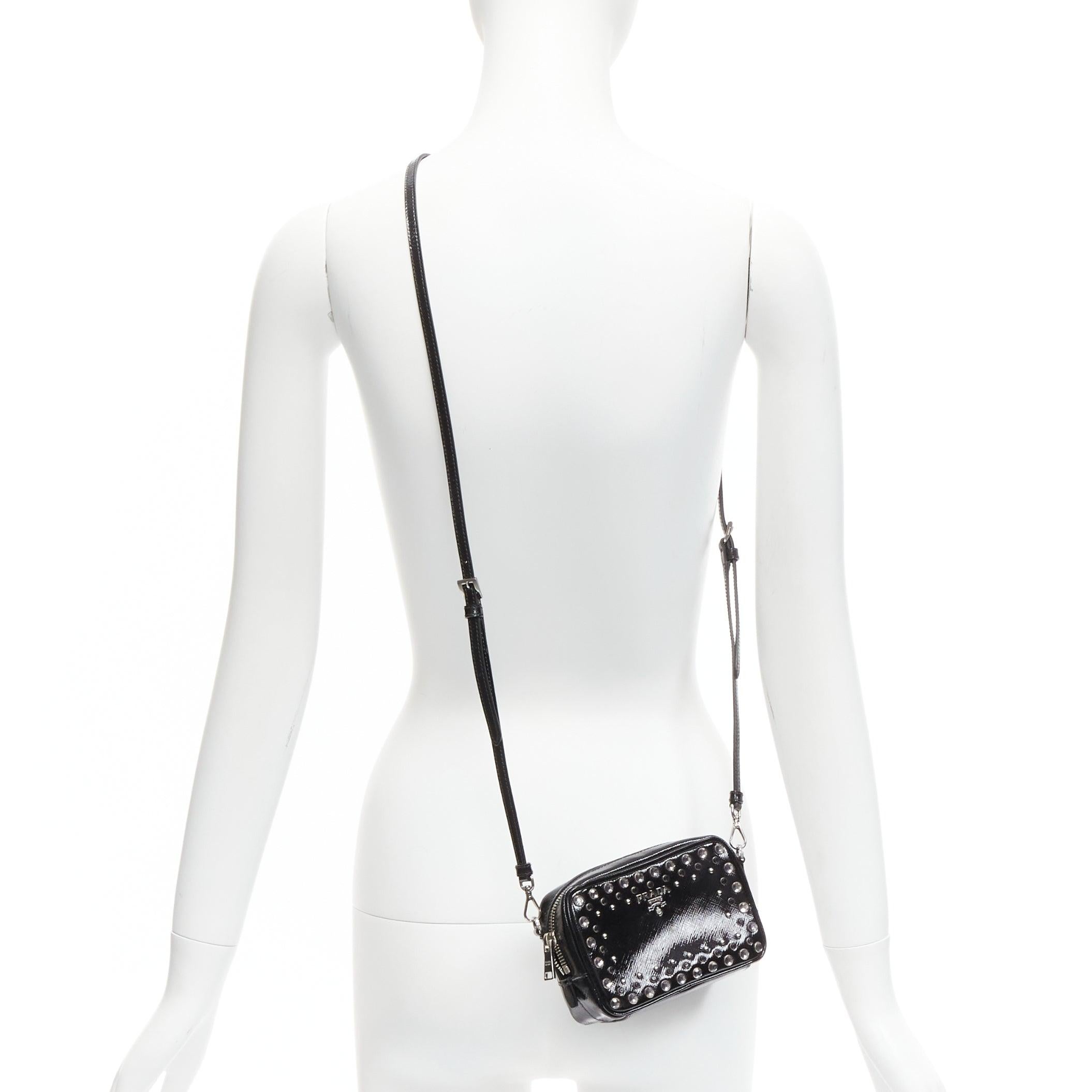 PRADA crystal silver stud logo black saffiano leather crossbody camera bag
Reference: TGAS/D00674
Brand: Prada
Designer: Miuccia Prada
Material: Leather
Color: Black, Silver
Pattern: Solid
Closure: Zip
Lining: Black Fabric
Extra Details: Signature