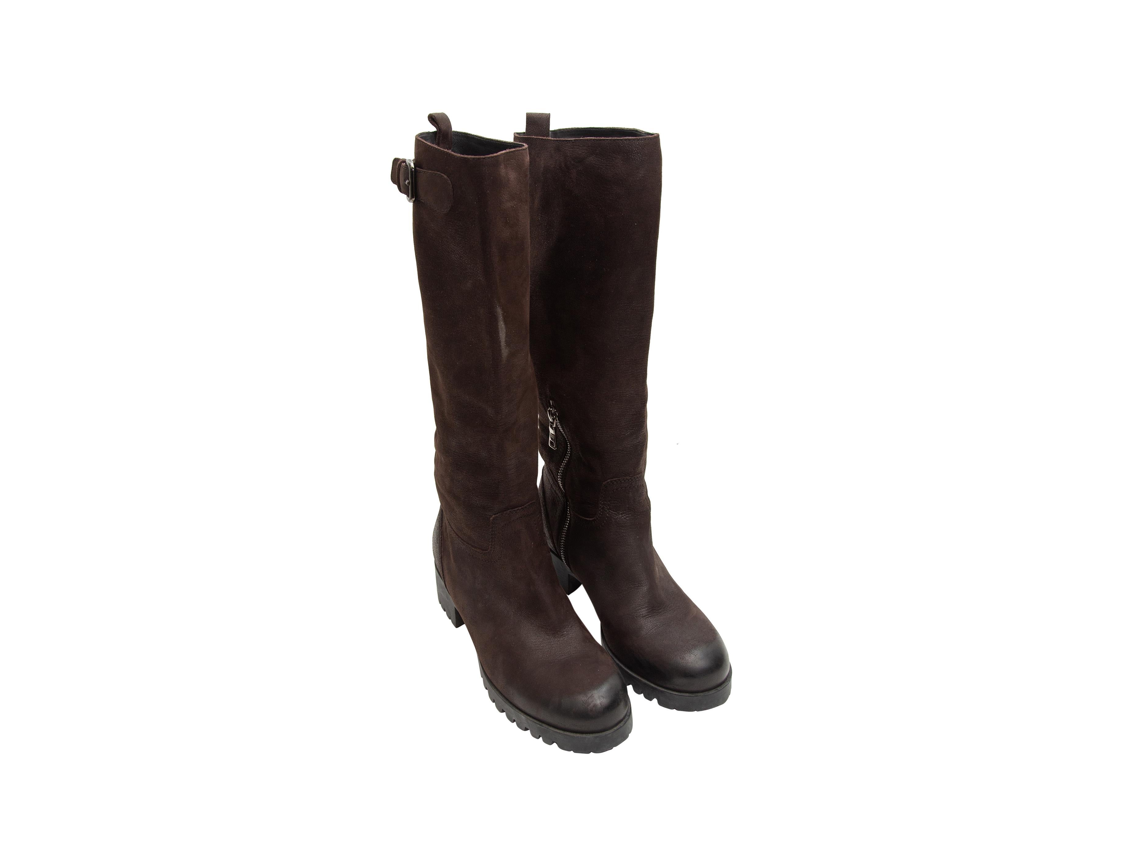 Product details: Dark brown leather tall riding boots by Prada. Buckle accents at outer sides. Lug soles. Zip closures at inner sides. Designer size 38. 1.5