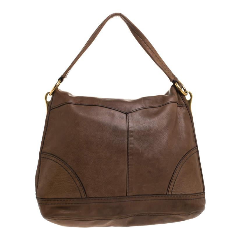 Prada bags are on every fashionista's list. They are highly coveted for their exquisite craftsmanship and distinguished style. This hobo bag is no exception. Crafted meticulously from soft leather, it carries a stunning dark brown shade that is