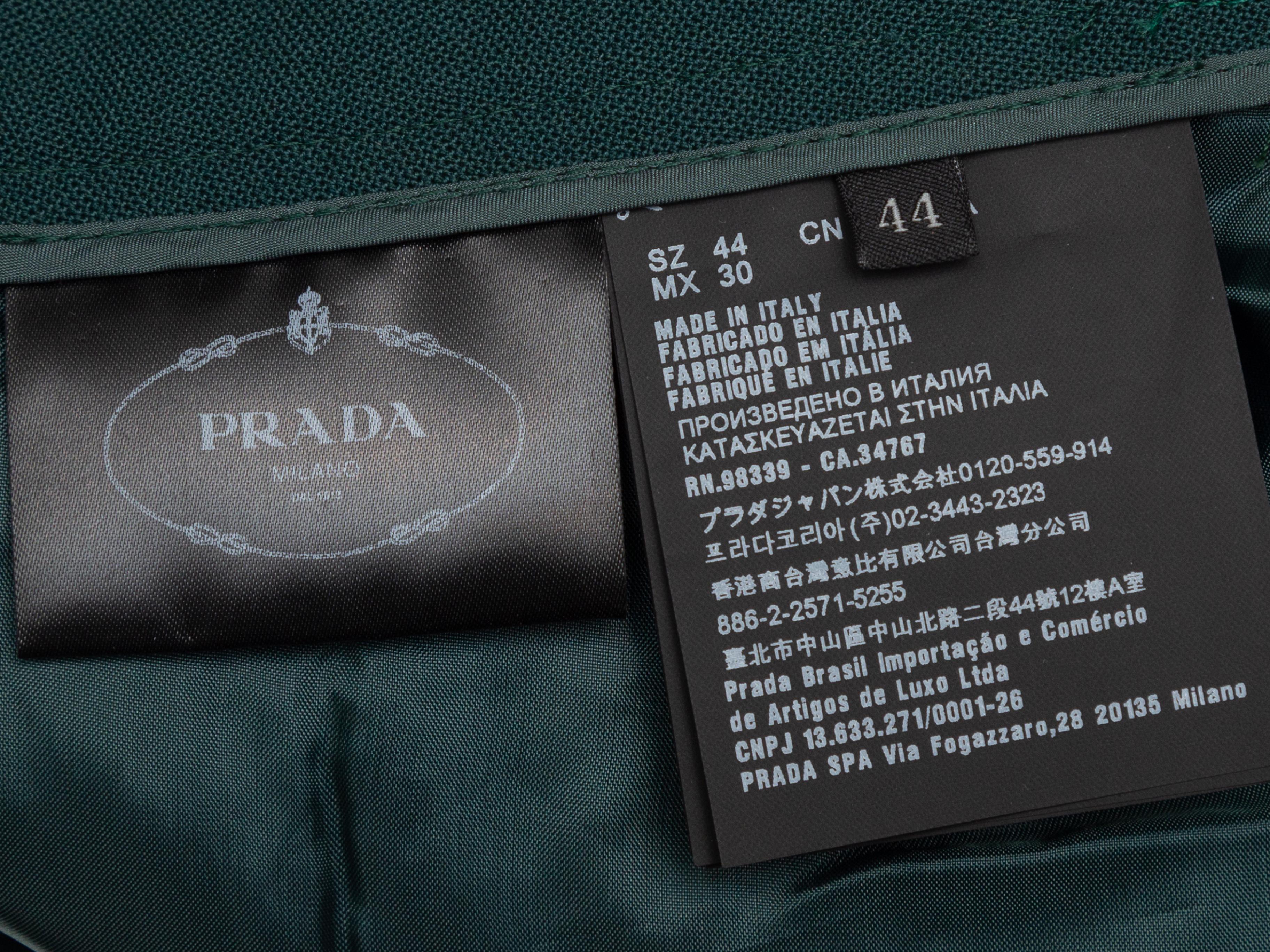 Product details: Dark green virgin wool pleated bootcut trousers by Prada. Five pockets. Zip closure at front. Designer size 44. 32