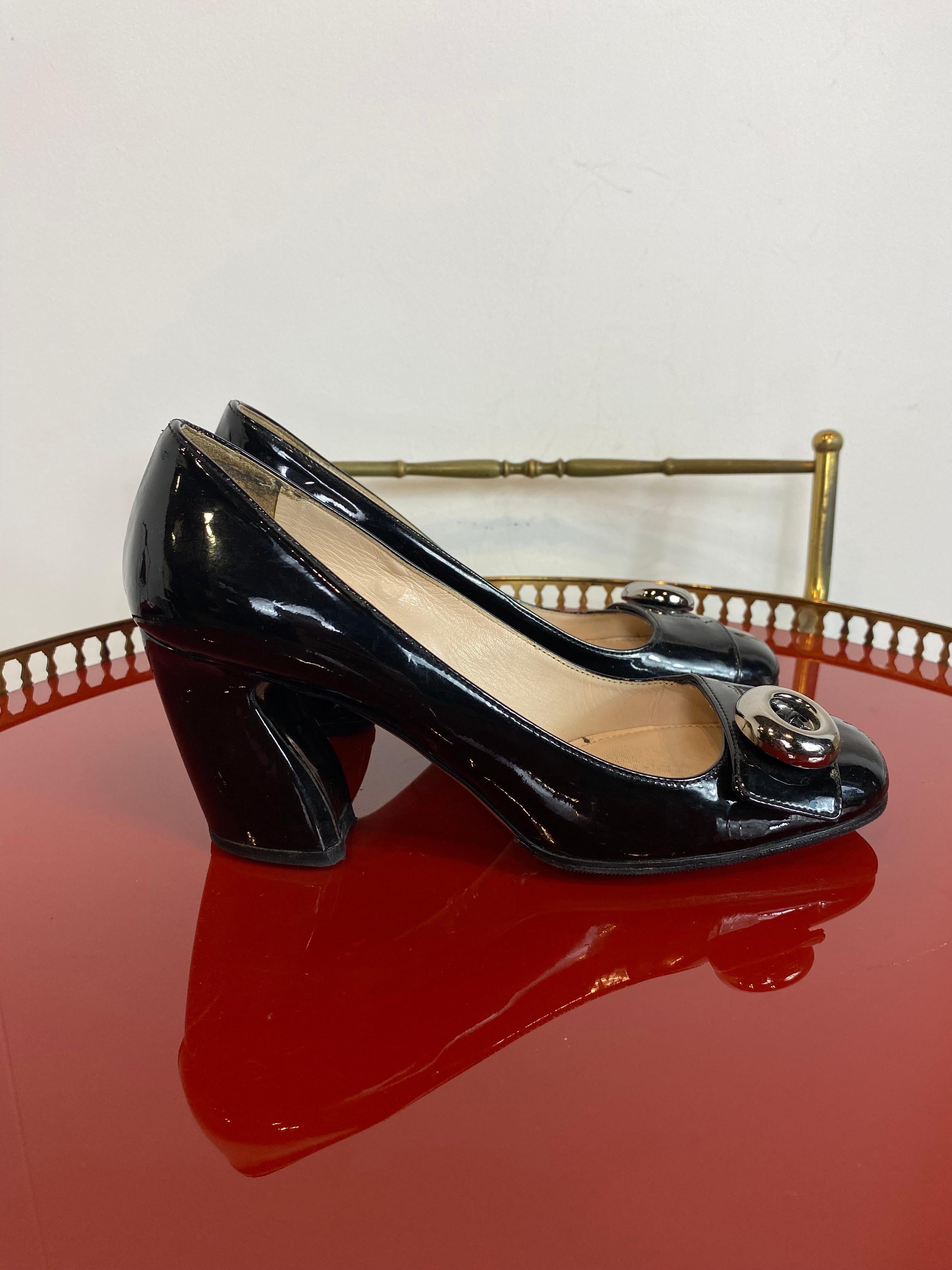 Prada patent leather pumps. Black with silver detail. 
They show signs of use as shown in the photo on the inside but overall they are in excellent condition. 

N 37.5 
Heel 7.5 cm