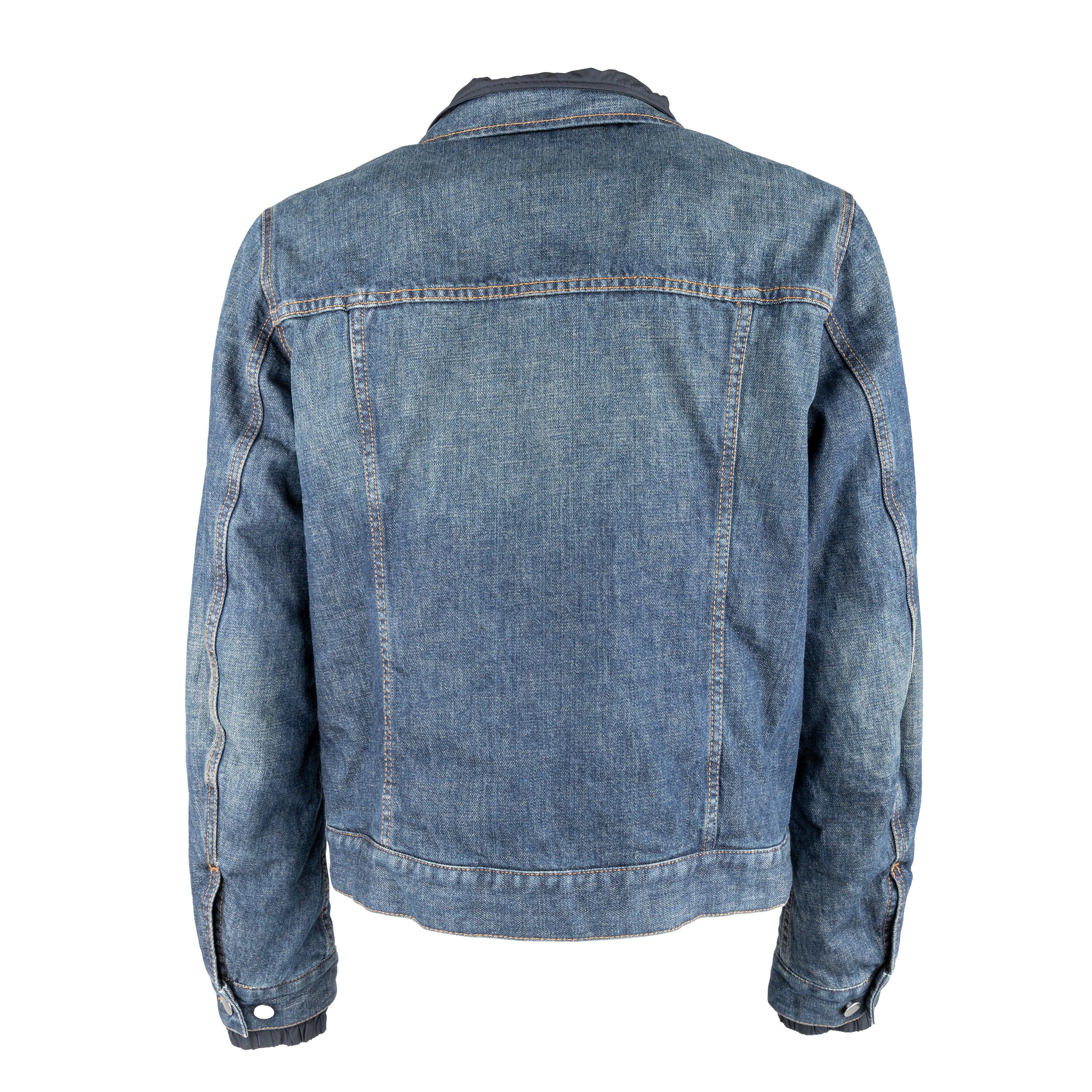 This Prada denim jacket, made of 100% cotton, features a polyester padding lining and zippered pocket for convenience. With its classic denim in blue and silver tone button closure in front, it exudes timeless style. The Prada stencilled logo on the