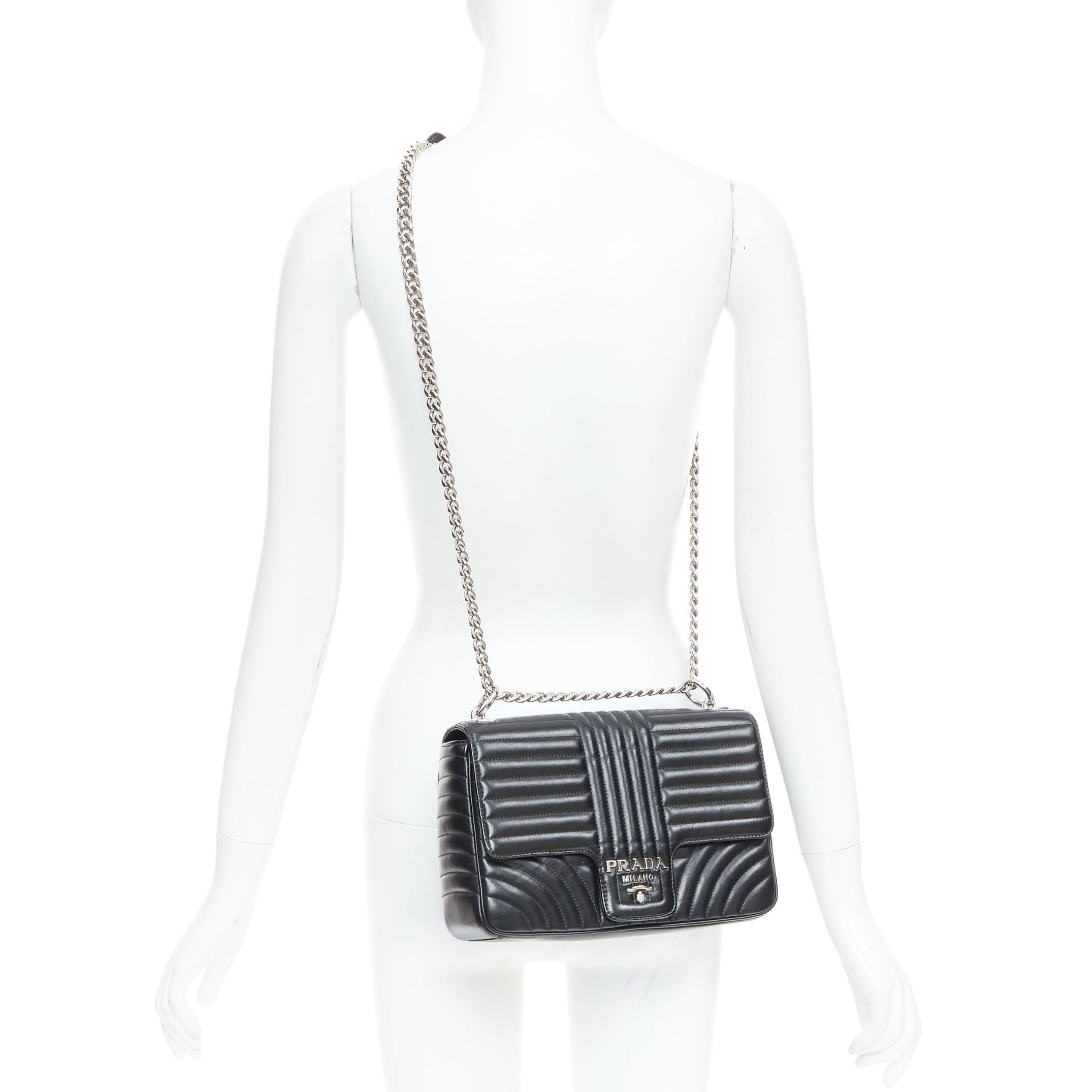 PRADA Diagramme black quilted silver logo crossbody flap shoulder bag
Reference: NILI/A00098
Brand: Prada
Designer: Miuccia Prada
Model: Diagramme
Material: Leather, Metal
Color: Black, Silver
Pattern: Solid
Closure: Magnet
Lining: Black