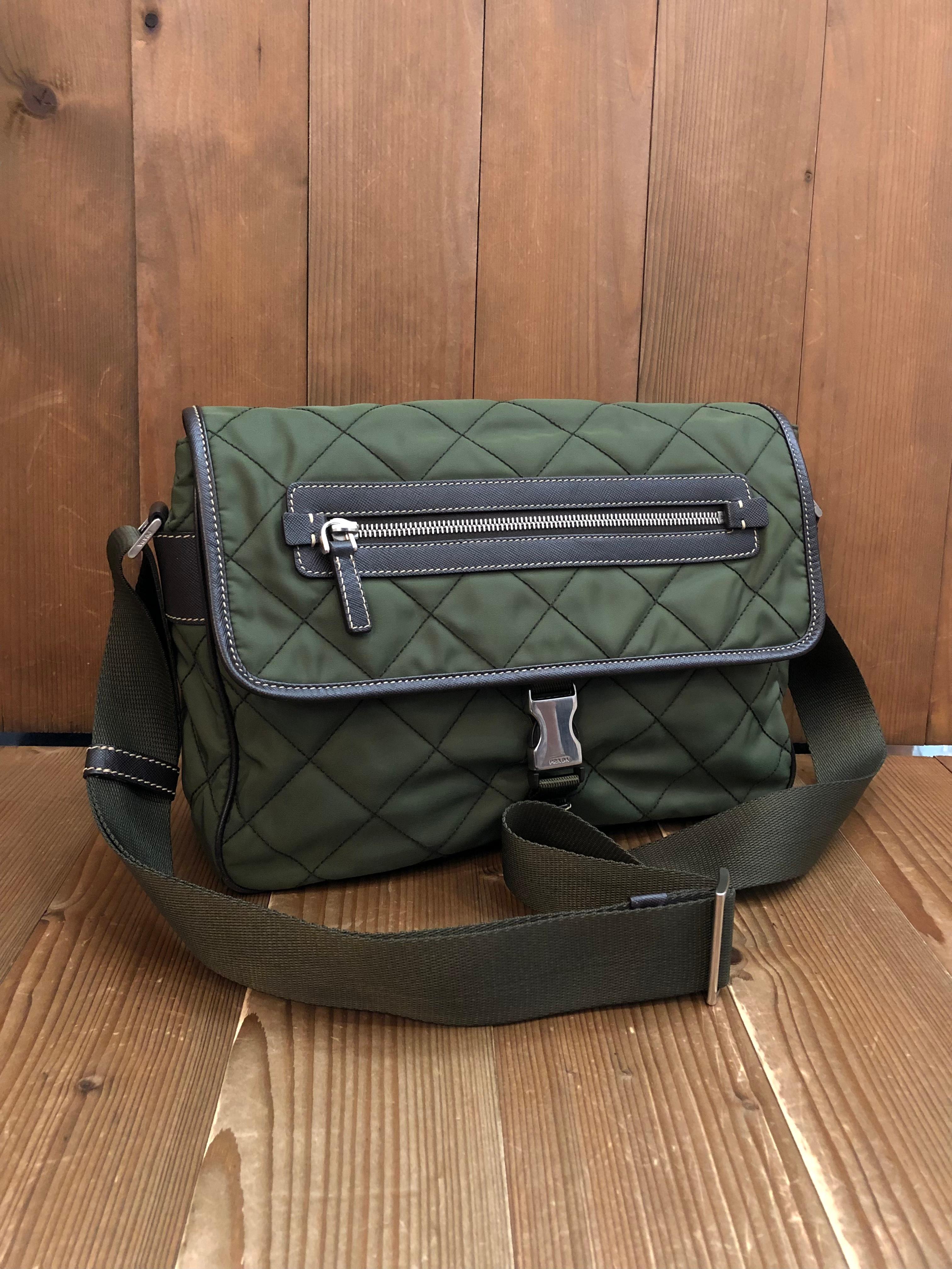 This stylish PRADA messenger crossbody bag is crafted of diamond quilted Tessuto polyester in army green featuring stainless steel hardware and Saffiano leather trims. Front flap buckle closure opens to an army green jacquard interior featuring a