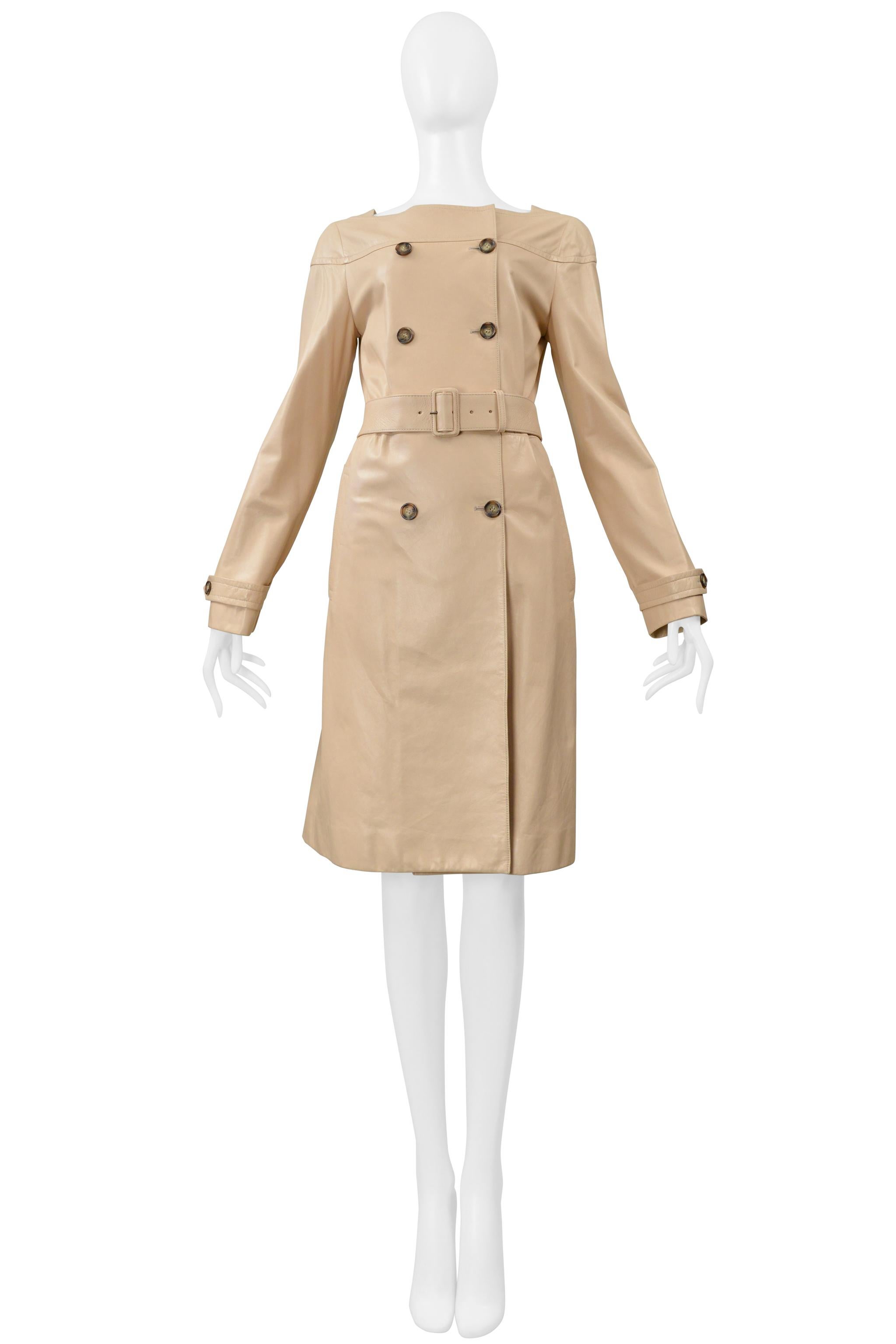 Resurrection Vintage is thrilled to offer a beautiful vintage Prada double-breasted beige leather coat dress with a belt. This coat dress features tortoise print buttons, side pockets, buttoned sleeves, acetate lining, and