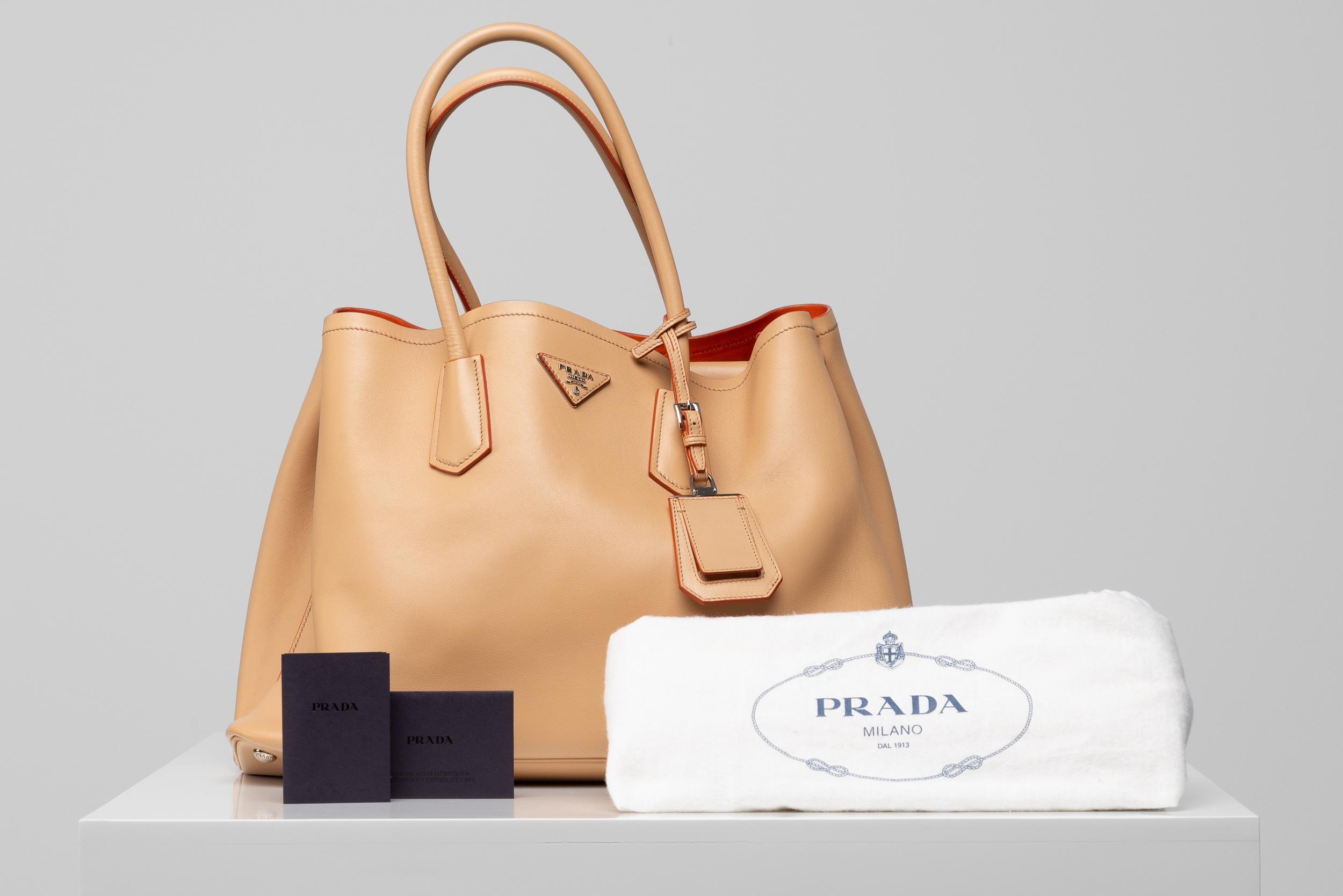 From the collection of SAVINETI we offer this Prada Double Bag:
-	Brand: Prada
-	Model: Double Bag Beige
-	Year: 2022
-	Condition: Very Good
-	Extras: dustbag, id-card and authenticity certificate from Entrupy

We at SAVINETI sell rare and preloved