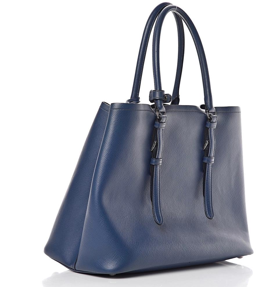 Prada Double Saffiano Cuir Bluette Leather Tote, Brand New
Prada saffiano leather tote bag.This bold tote is crafted of Prada saffiano crossgrain leather in navy blue.
Silver hardware; tonal top stitching.
Rolled top handles with strap keeper