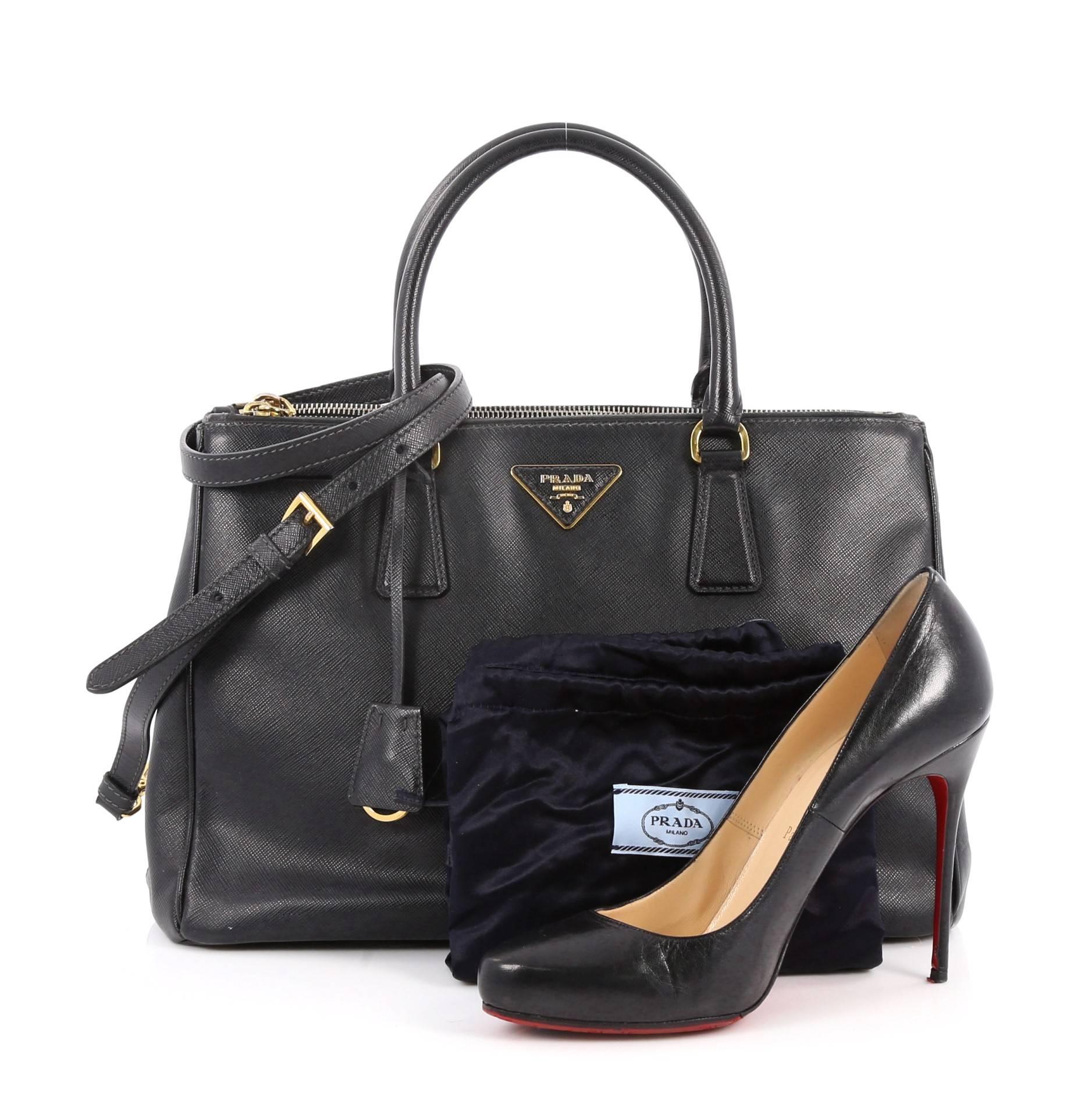 This authentic Prada Double Zip Lux Tote Saffiano Leather Medium is the perfect bag to complete any outfit. Crafted from black saffiano leather, this boxy tote features side snap buttons, raised Prada logo plate, dual-rolled leather handles and