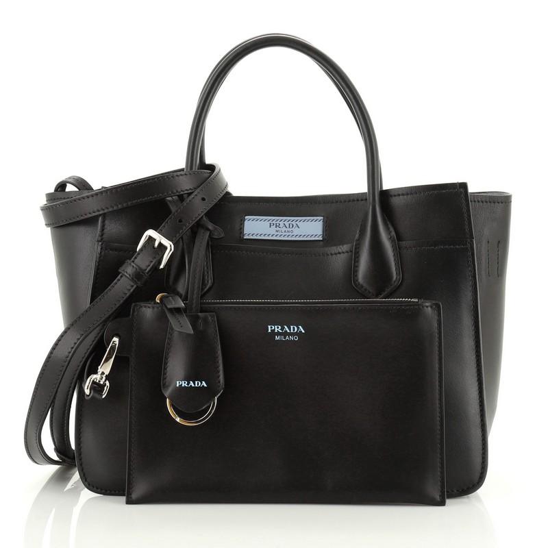 This Prada Dual Shopping Tote Calfskin Medium, crafted from blue calfskin leather, features dual rolled handles, exterior slip compartments and silver-tone hardware. It opens to a blue suede interior. 

Estimated Retail Price: $1,950
Condition: Very