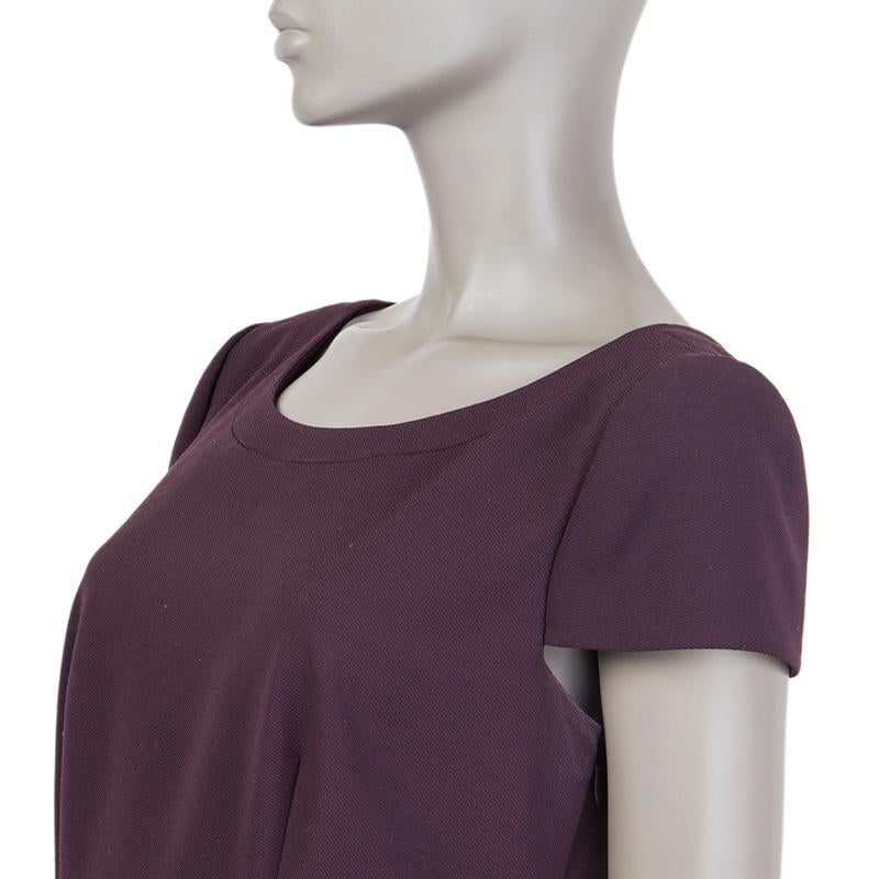 Prada cap-sleeve sheath dress in eggplant virgin wool (60%), polyester (26%), nylon (10%), and elastane (4%). Closes with invisible zipper on the side. Lined in eggplant silk (92%) and elastane (8%). Has been worn and is in excellent condition. Note