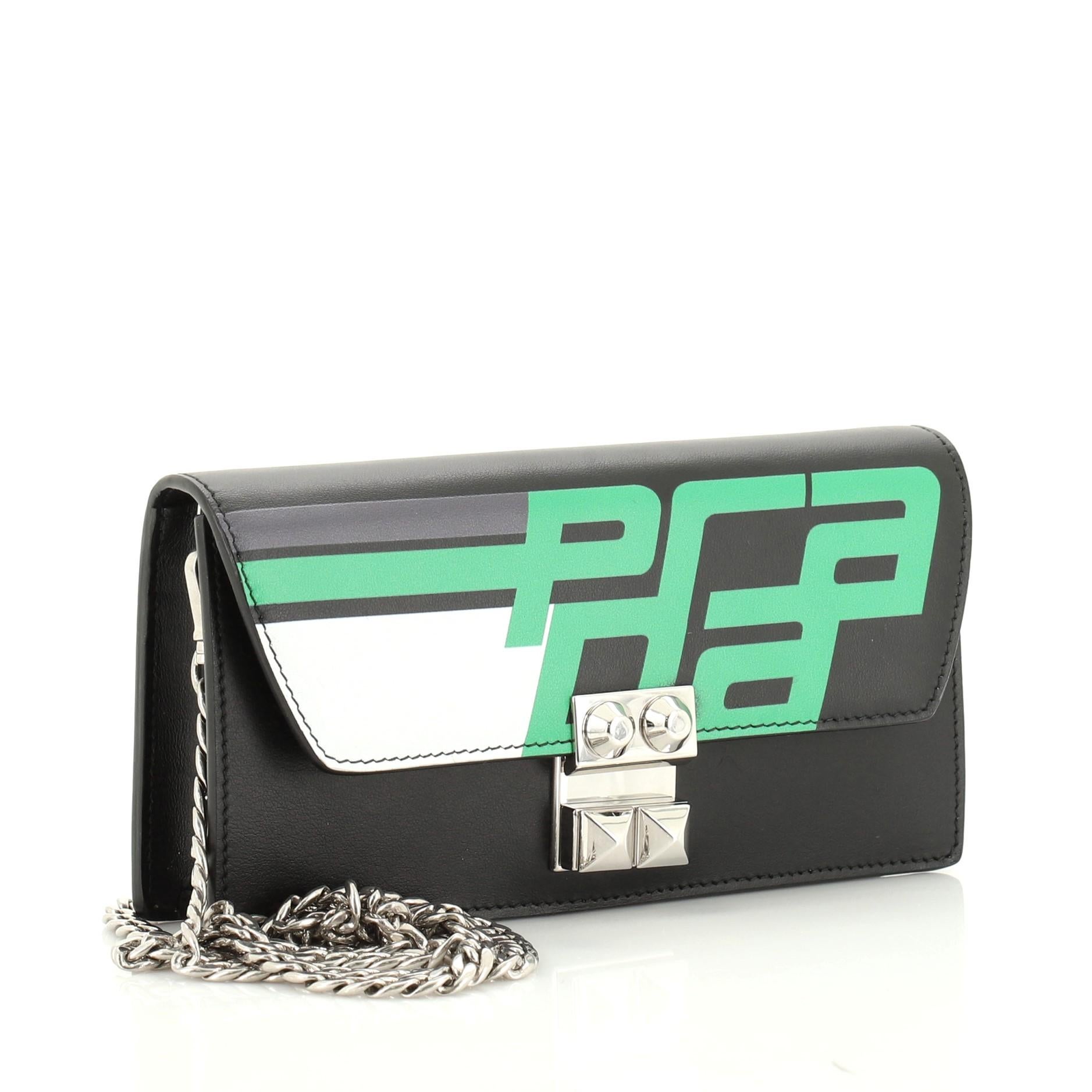 This Prada Elektra Wallet on Chain Printed Leather, crafted from black printed leather, features chain link strap, printed Prada logo on the front flap and silver-tone hardware. Its push-lock closure opens to a black leather interior with slip