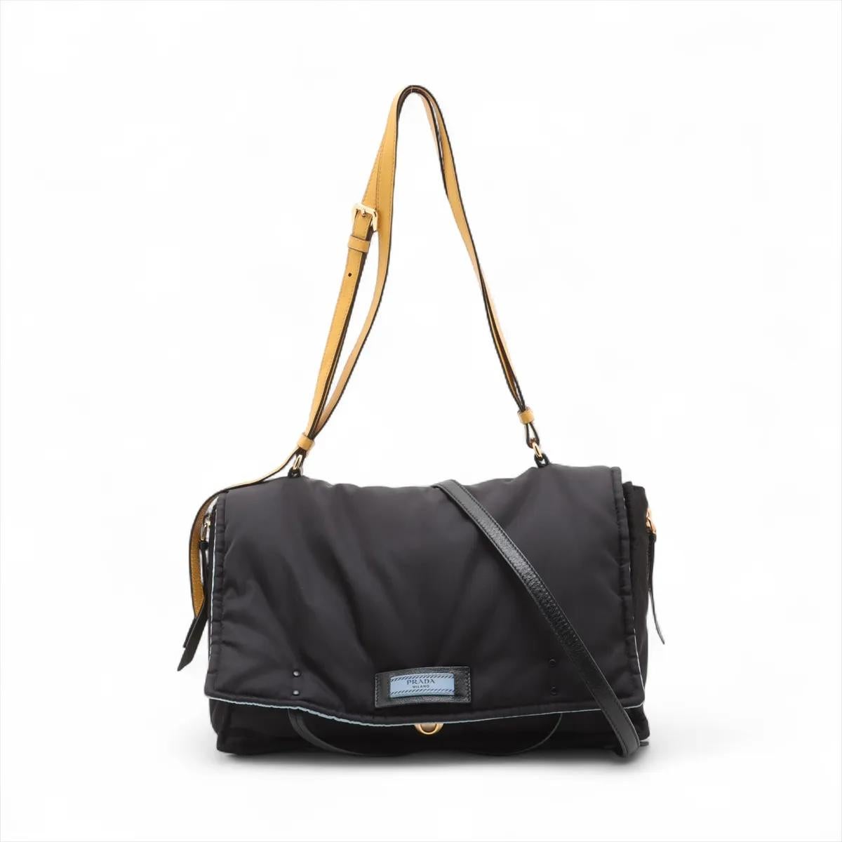 The Prada Etiquette Nylon Two-Way Shoulder Bag in black is a modern and versatile design that blends practicality with understated elegance. Crafted from durable nylon and accented with supple leather trim, it is finished with the signature Prada