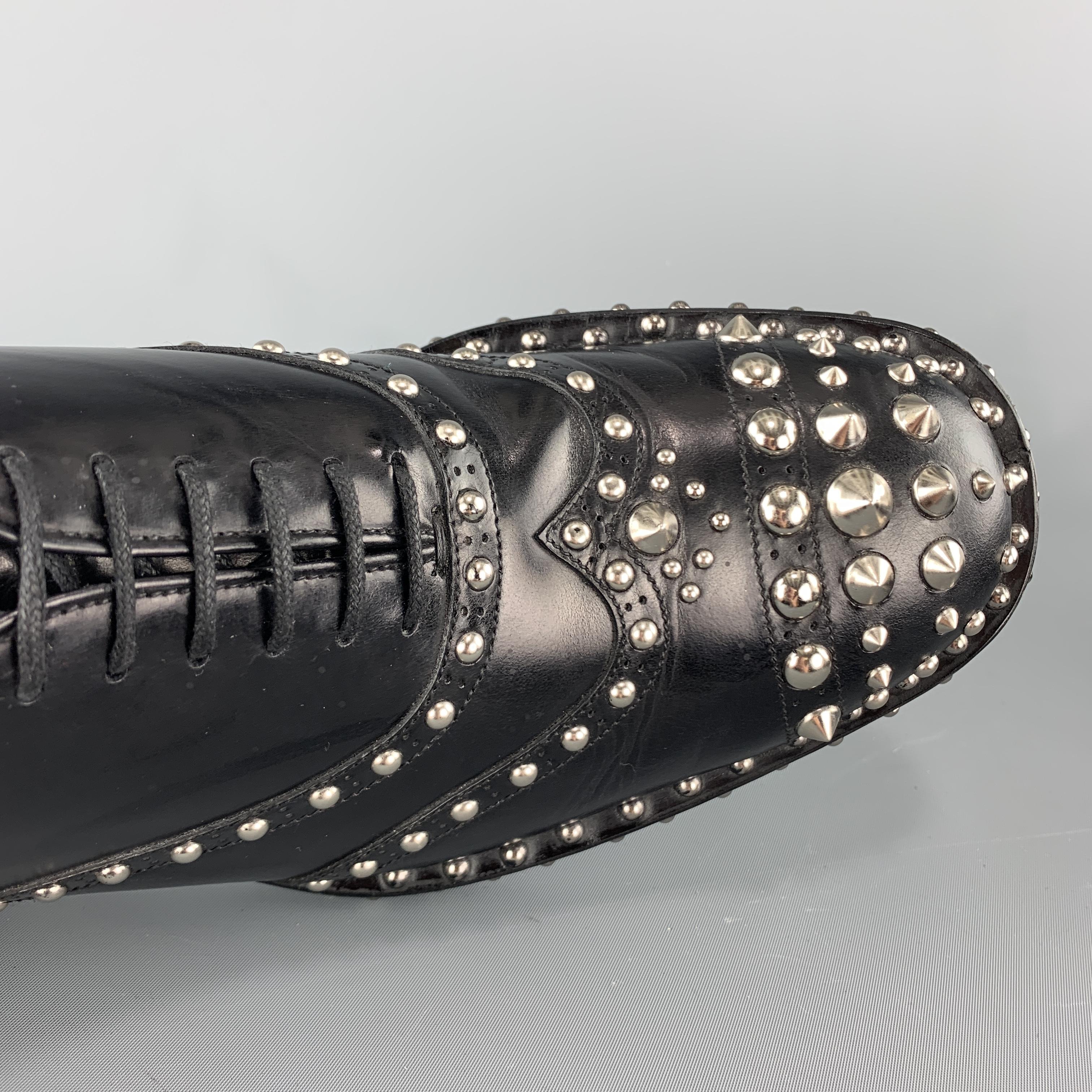 Iconic PRADA Fall / Winter 2009 Collection dress shoes come in polished black leather with a wingtip and silver tone dome and cone spike studs throughout. With box. Made in Italy.

Excellent Pre-Owned Condition.
Marked: UK 7.5

Outsole: 12 x 4.5 in.