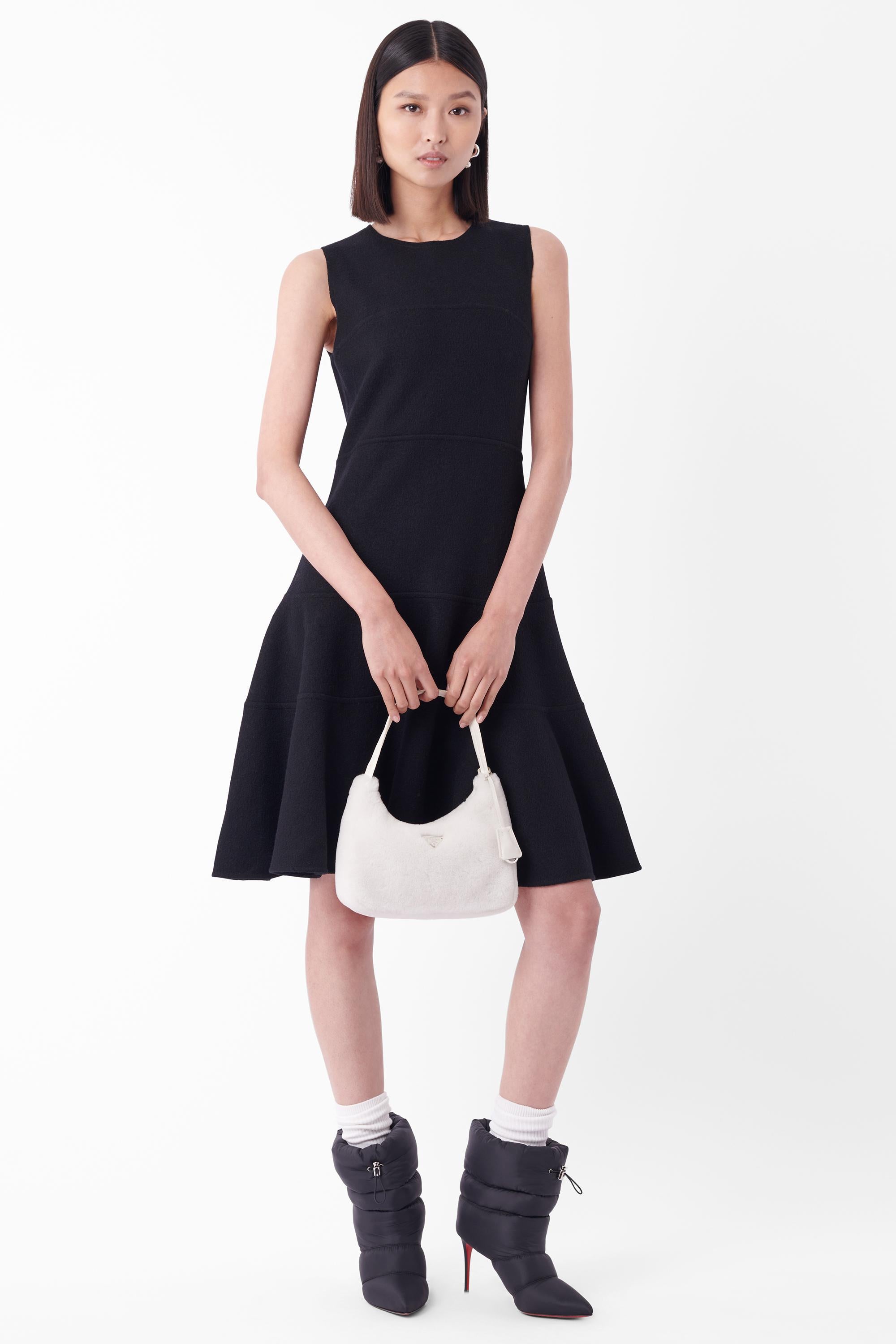 We are excited to present this Prada Fall Winter 2006 black wool dress. Features horizontal panelling, a-line silhouette and back zip closure with ‘Prada’ hardware. In great vintage condition.

Brand: Prada
Size: UK 8
Colour: Black
Tag Size: IT