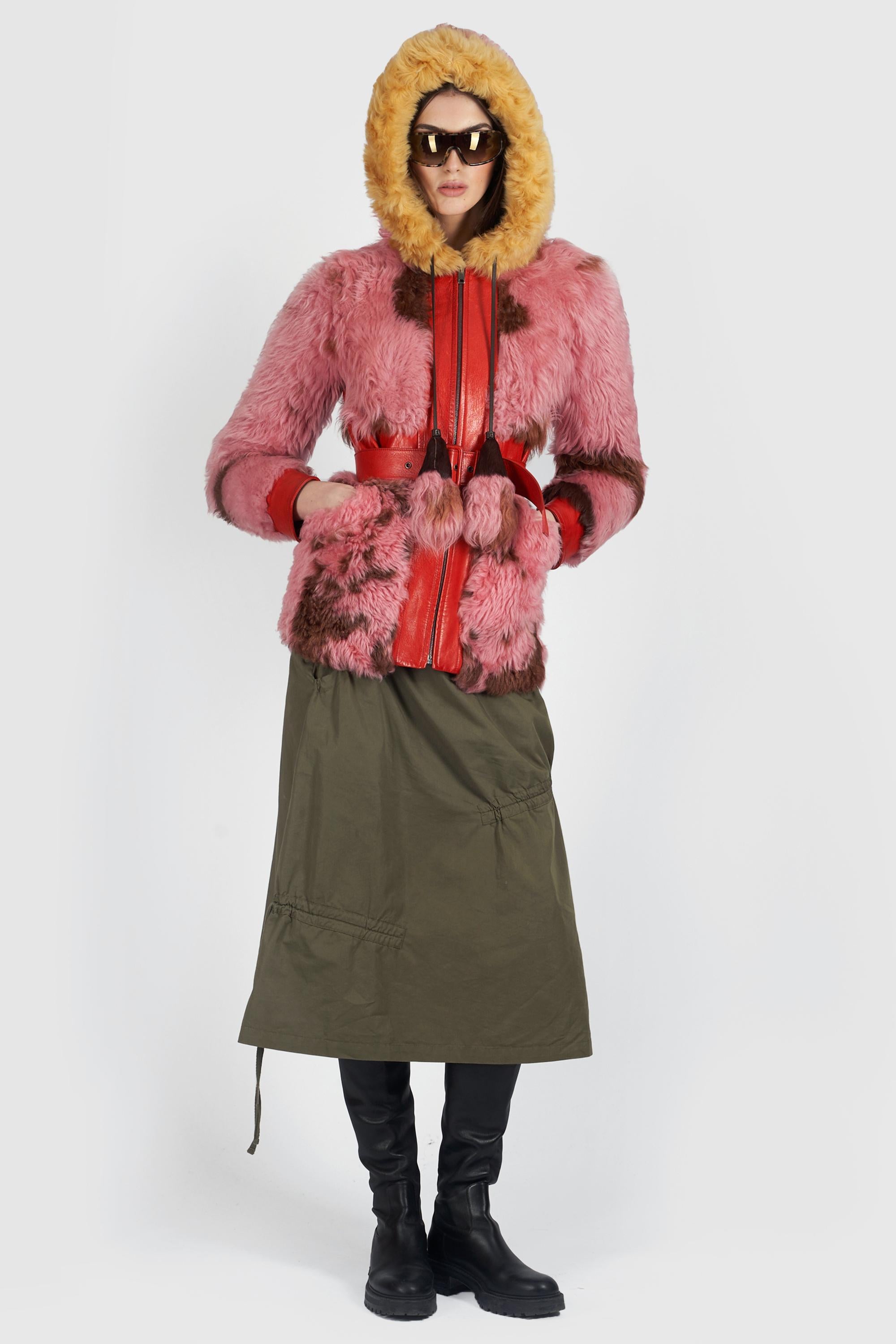 Cappotto con cappuccio in shearling rosa di Prada Autunno Inverno 2017. Presenta tasche, finiture in pelle rossa, cintura e cappuccio con zip frontale. In ottime condizioni vintage, si prega di notare che ci sono alcuni piccoli segni sulla fodera