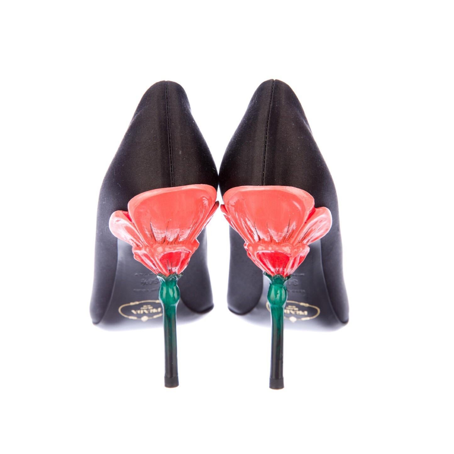 Prada Fairy Collection Black Raso Chic Pumps.
Done in silk satin with an open toe and a sculpted lacquered flower heel.
Size 4.5 U.S, 34.5 IT
- Follow us on Instagram @BASHAGOLD
