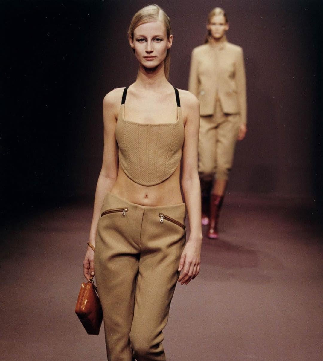 Prada golden colour nylon corset from Fall Winter 1999 collection as seen on the runway and campaign in other colours and materials. The corset is adjustable in the back as the straps are elastic and close with velcro in the back. 
Size is Italian