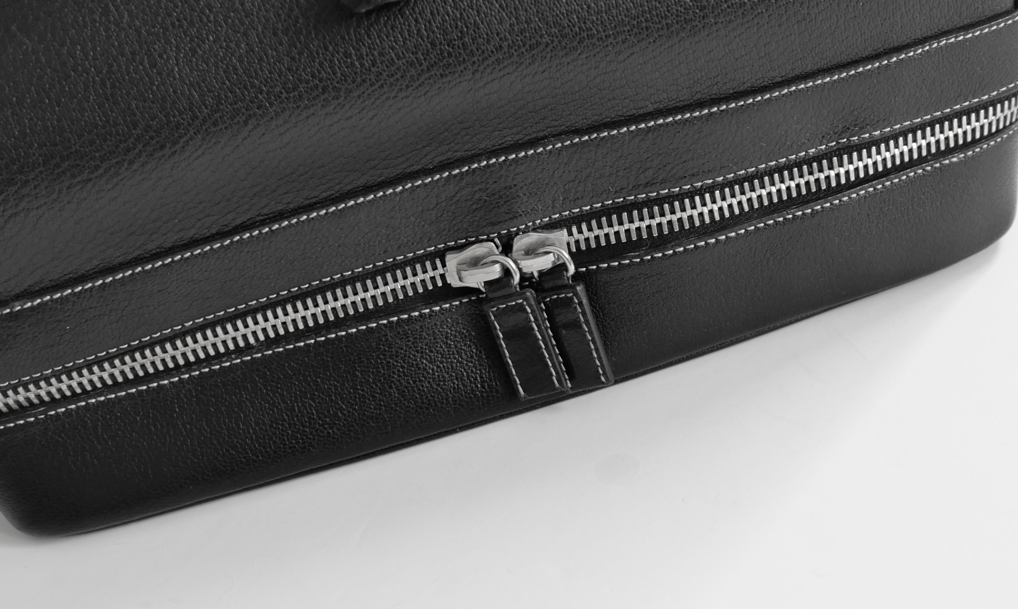 Incredibly rare Prada doctor’s bag from the AW00 collection. This is an absolute grail piece for Prada collectors and price reflects this. If you know, you know! Made from thick black leather with silvertone hardware. It has a vintage inspired top