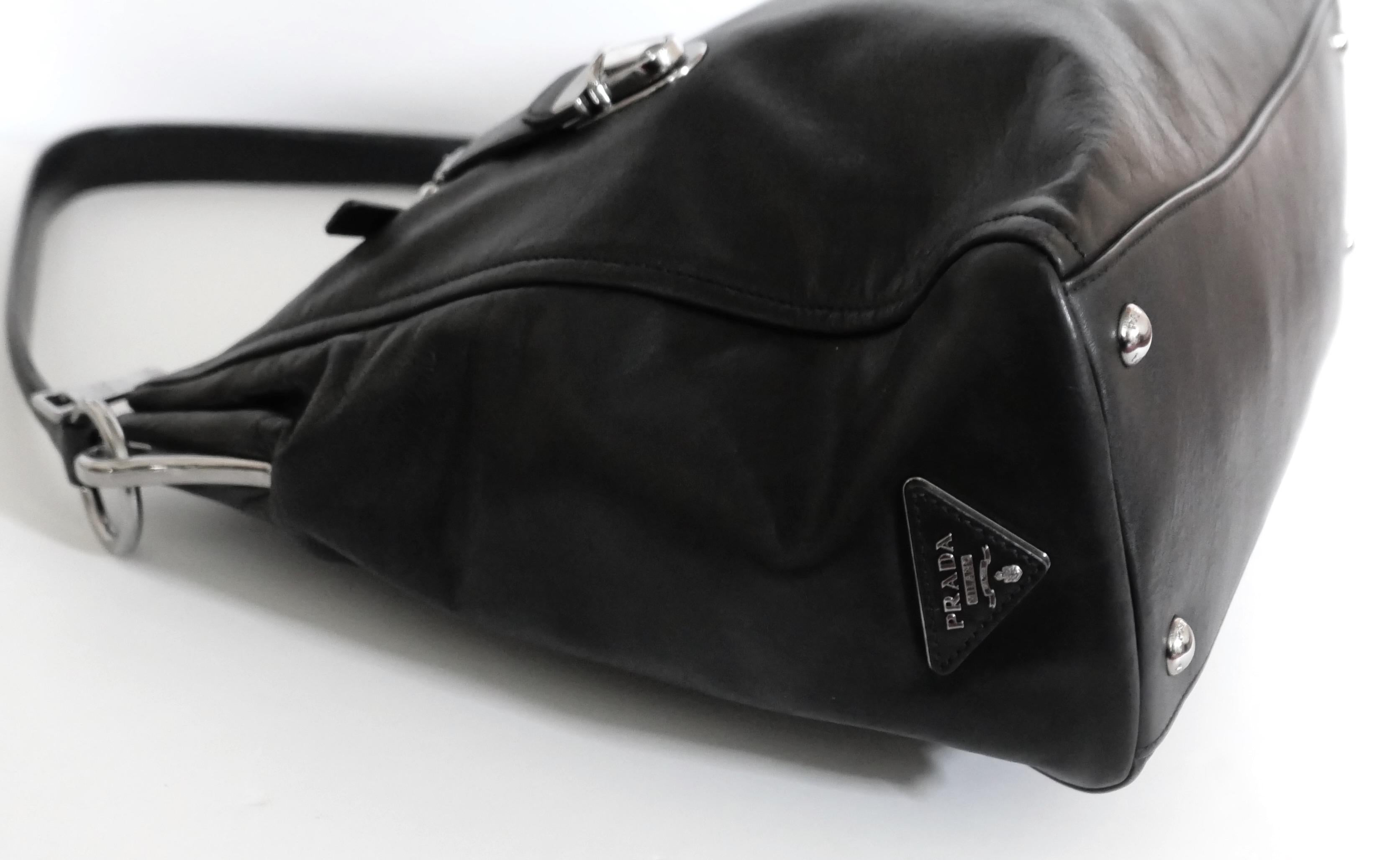 Impresionante bolso tote vintage Prada de piel negra con cremallera de la colección Otoño 2003. Usada una sola vez, está absolutamente inmaculada y viene con bolsa guardapolvo. Un tamaño muy amplio en piel negra supersuave con preciosos y gruesos