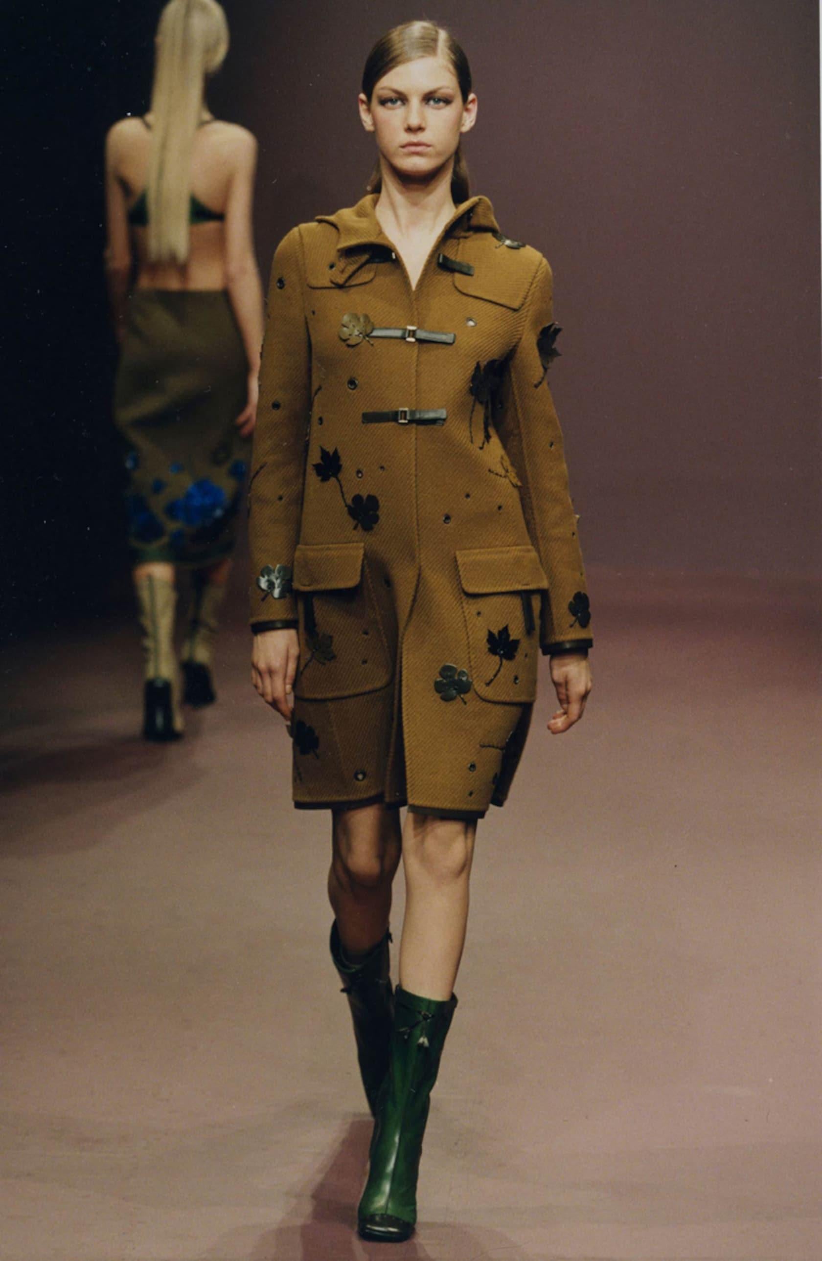 A highly collectible coat from Prada’s Fall/Winter 1999 collection, this piece embodies the intelligent minimalism and utilitarian luxury that defined Miuccia Prada’s late-90s aesthetic. The season showcased modern reinterpretations of classic