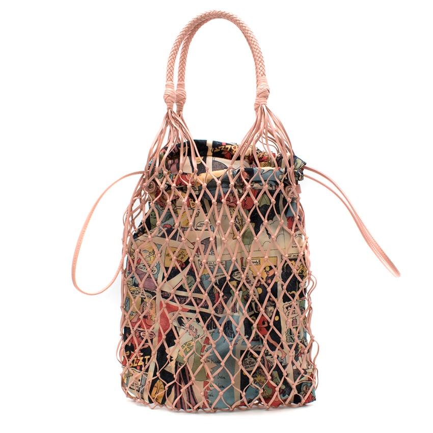 Prada Faux leather mesh and nylon bucket bag with Comic Print Slip Bag

-orchid blush colour - mesh outer - woven top handles - drawstring closure - fabric comic print pouch - plated triangle logo

Please note, these items are pre-owned and may show