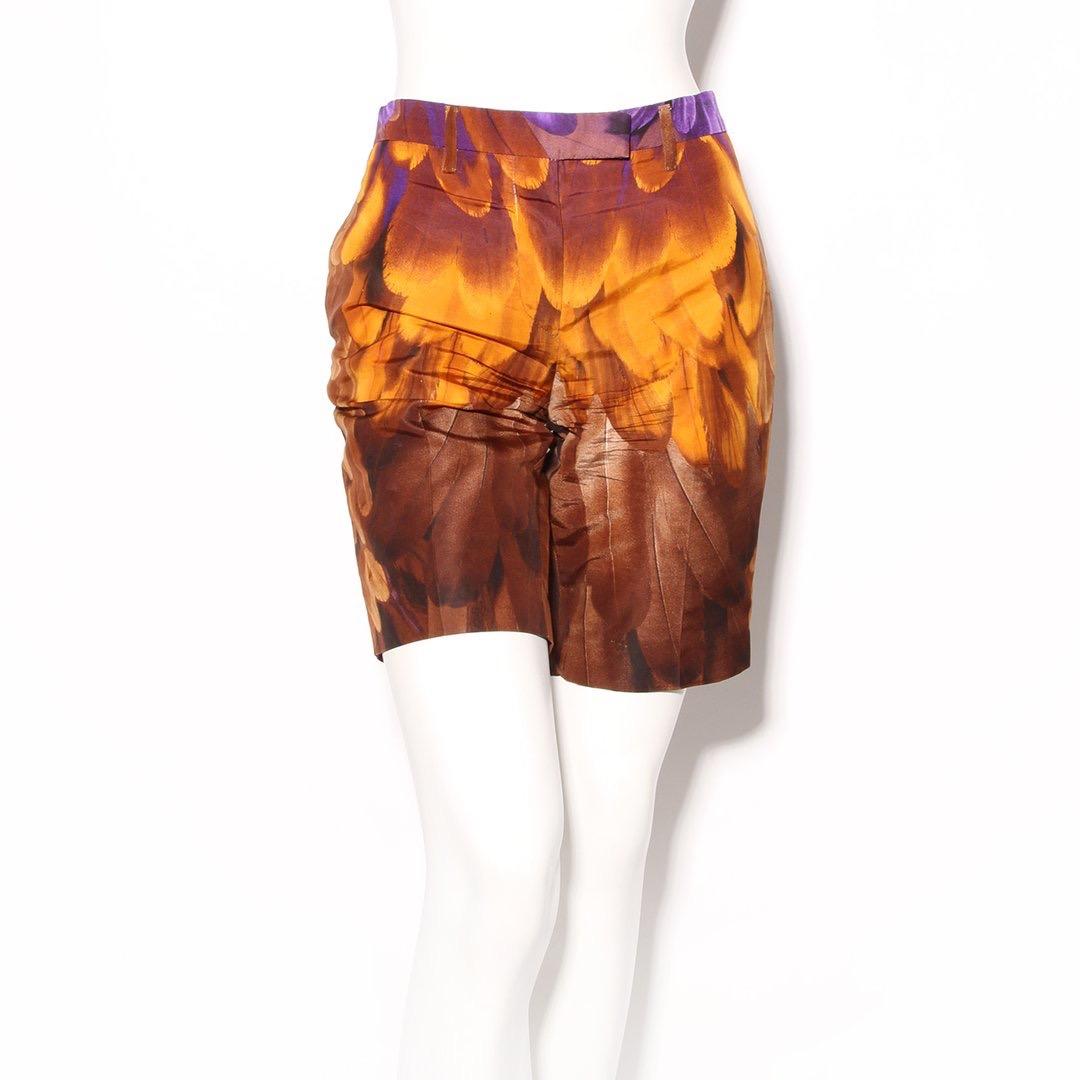 Feather shorts by Prada 
Spring/summer 2005 RTW collection
Purple, orange, and multicolor print 
Feather print
Zip front with hook and eye and button closure
Silver-tone hardware
Belt loops 
Two side pockets 
One back pocket 
100% silk
Made in