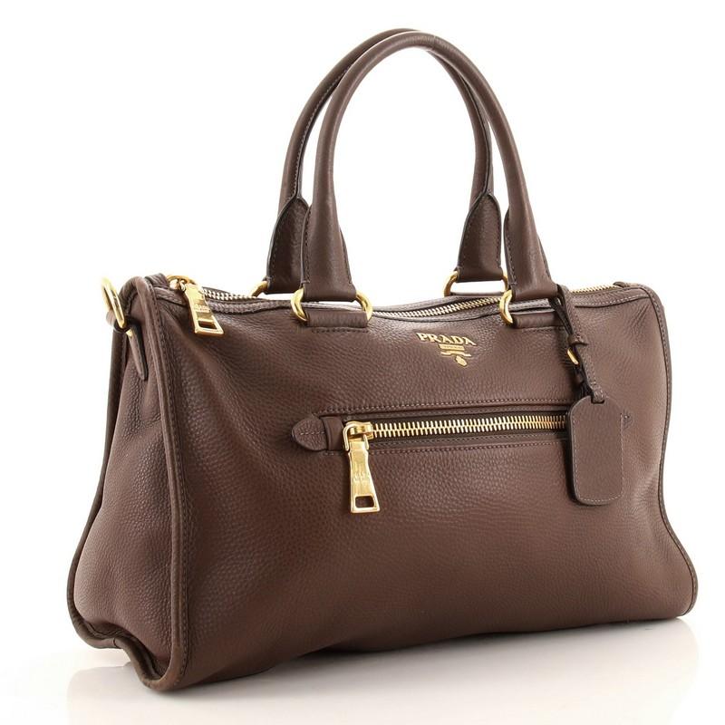 Condition: Good. Odor in interior. Heavy discoloration and wear on base corners, creasing on exterior, darkening and wear on handles and strap. Cracking on strap base wax edges, scratches and discoloration on hardware.
Accessories: Luggage Tag, With