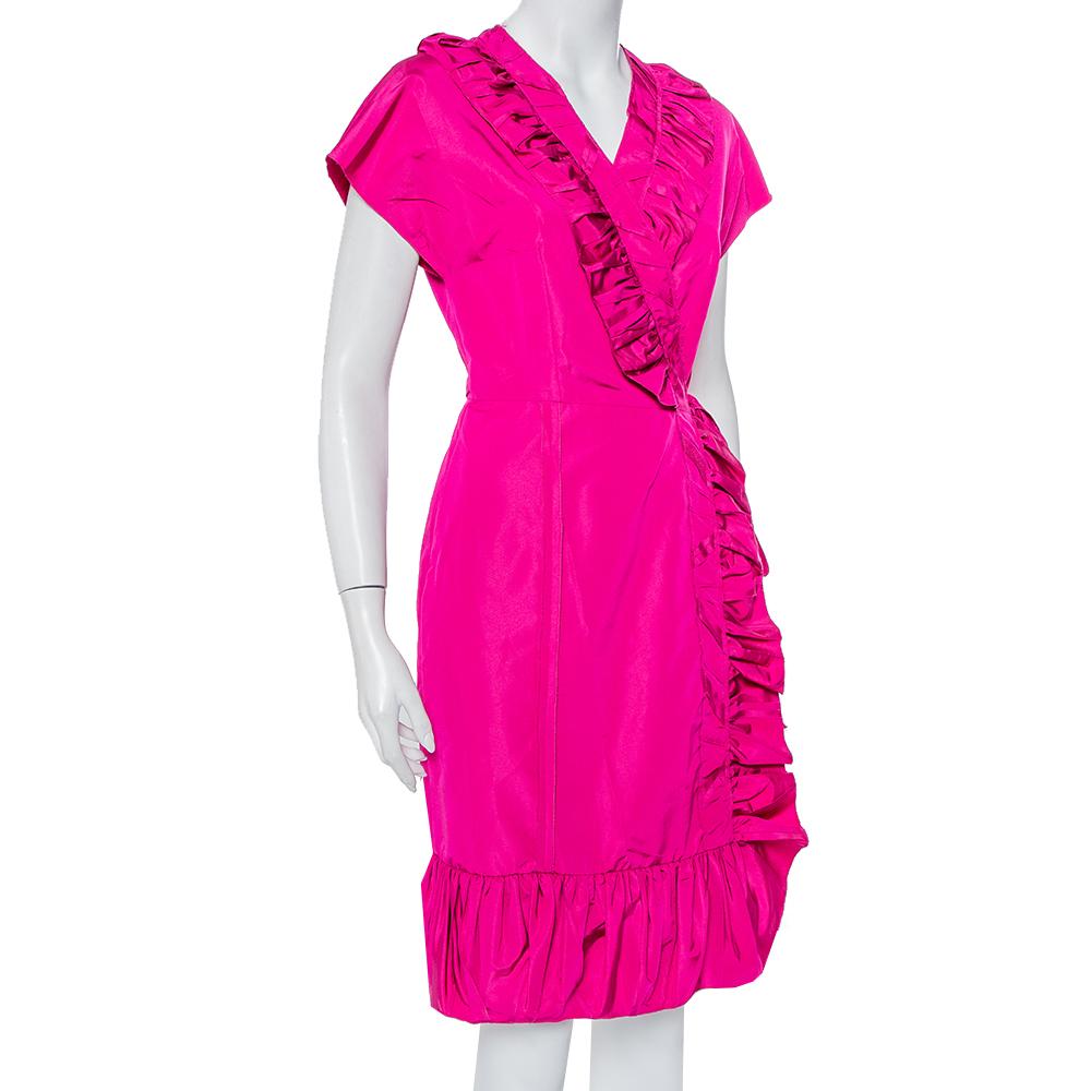 Playful and perfect for donning an effortless outfit that still makes a statement, this Prada dress is a beauty. Crafted from a silk blend, this fuchsia pink dress has a wrap silhouette. It comes with short sleeves, ruffle detailing and comfortable