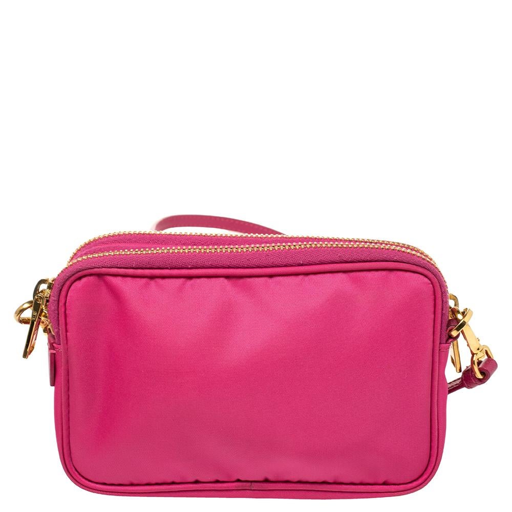 From the house of Prada comes this gorgeous mini crossbody bag. It has been crafted from nylon and accented with the brand label on the front. The top zippers open to reveal nylon compartments and the bag is complete with a leather shoulder strap.

