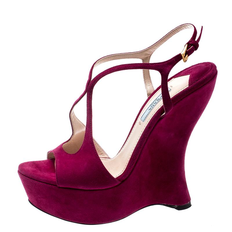 Take these platform sandals from the house of Prada out for a spin and wow your peers with its bright fuschia pink hue and curved heels. They feature a suede body, a cutout design on the uppers, and peep toes. They are beautiful, feminine and are