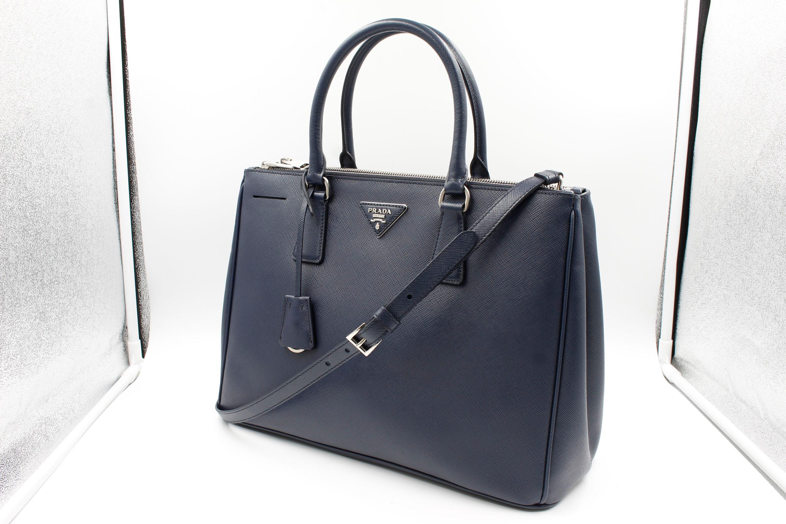 Prada's Galleria Saffiano tote is a perfectly prim addition to your accessories edit. Crafted from textured navy blue calf leather, this design is finished with dainty top handles and golden hardware. Double storage compartments leave ample room for