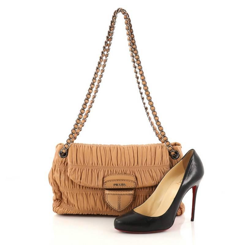 This authentic Prada Gaufre Chain Flap Shoulder Bag Nappa Leather Medium is the ideal bag for day to night. Crafted from light brown nappa leather, this flap bag features a ruched silhouette, exterior rear flat pocket, magnetic snap closure, dual